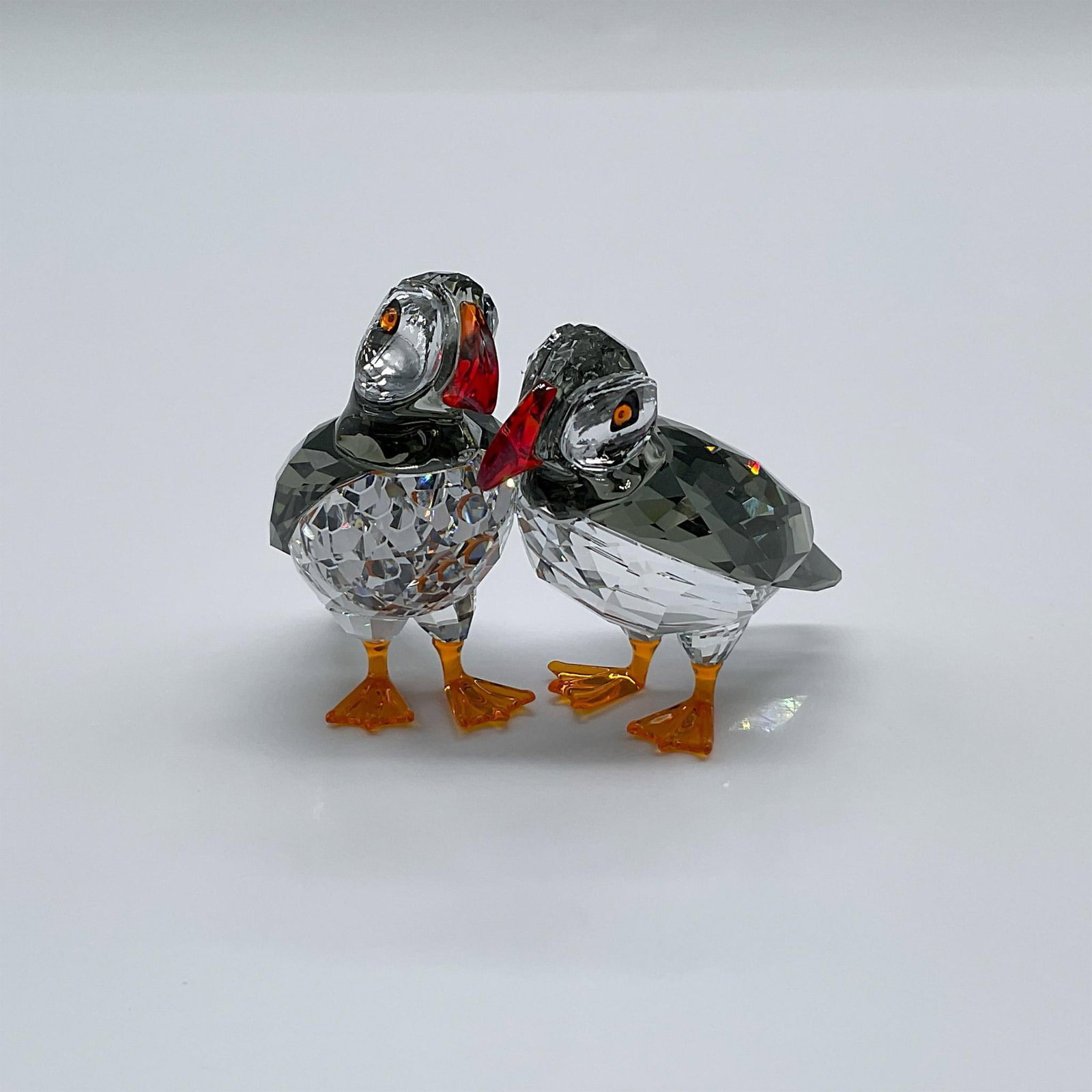 Swarovski Crystal Figurine, Atlantic Puffins: Part if the Feathered Beauties collection. An adorable pair of puffins beautifully crafted in clear crystals with red, black and orange color accents. Swarovski swan mark. This item has its original b