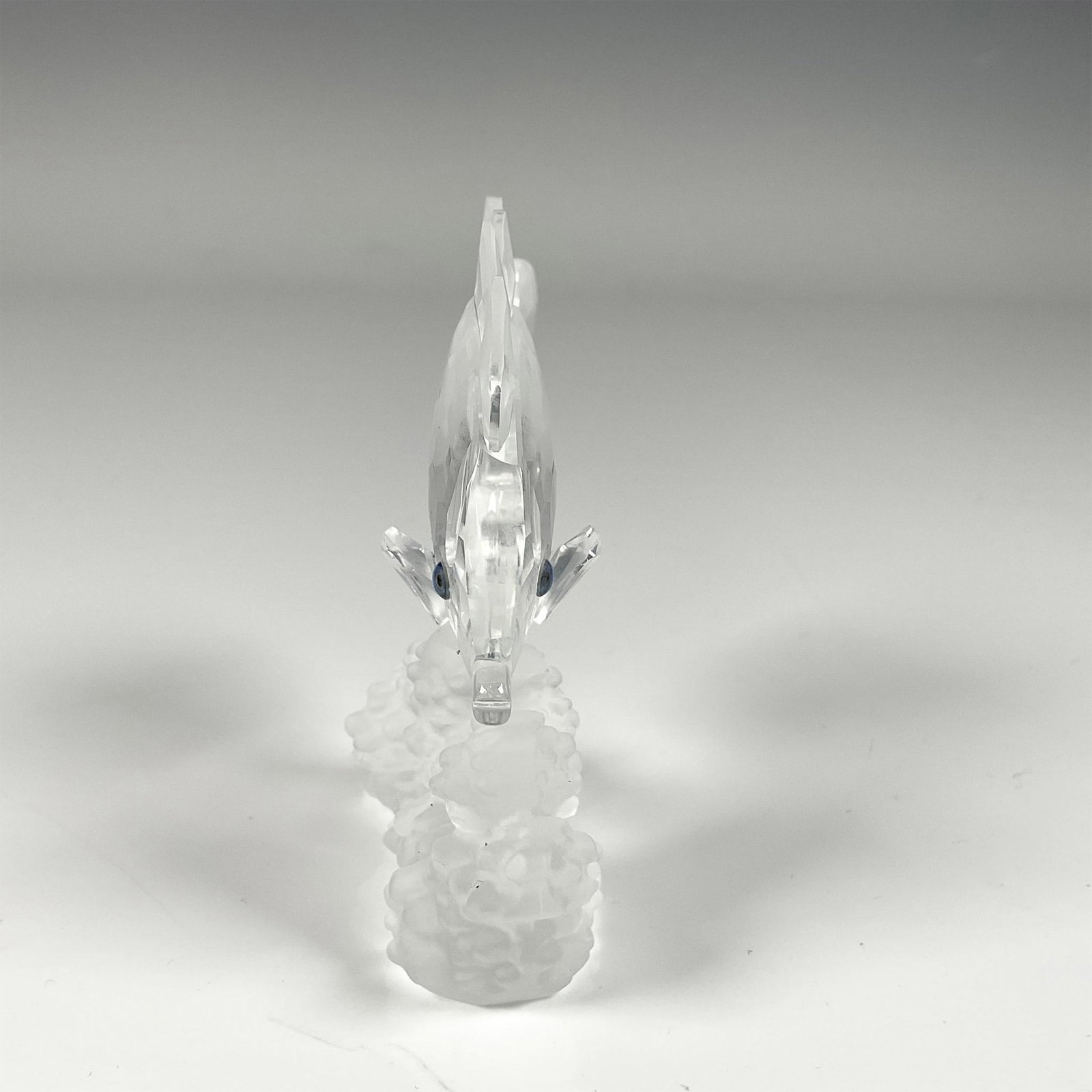 Swarovski Crystal Figurine, Butterfly Fish: Elegant clear crystal figure, featuring a butterfly fish on frosted crystal corals. Swarovski swan mark at the belly of the fish. This item includes original box: 5"W x 4.25"H. 162888. Artist: Michael
