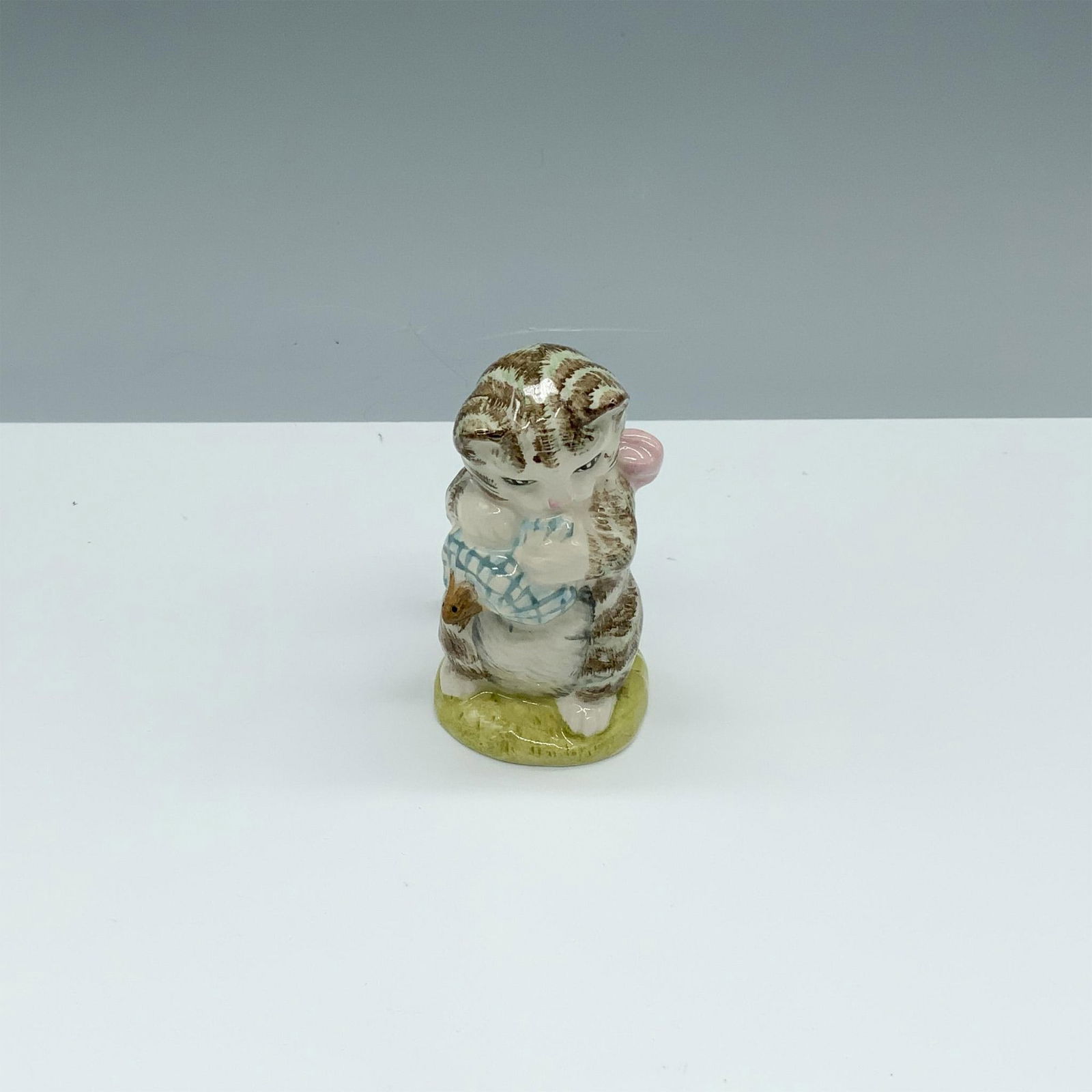 Royal Albert Beatrix Potter Figurine, Miss Moppet: Glossy porcelain figure of a small cat holding a mouse. Royal Albert Beatrix Potter backstamp. This item has its original box (2.5"L x 2"W x 5"H). Issued: c. 1989 Dimensions: 1.5"L x 2"W x 3"H Manufac