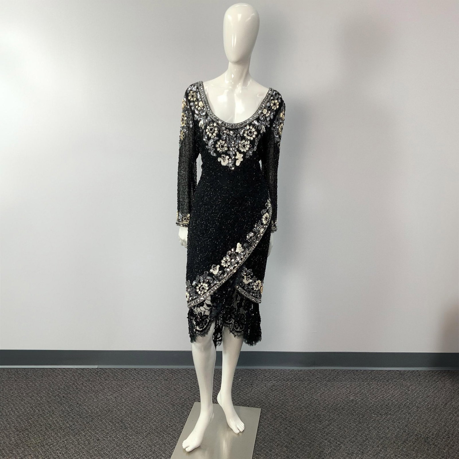 Black Tie Oleg Cassini Black Embroidered Evening Dress: Striking Black Tie Oleg Cassini embroidered beads and sequins flower patterns black silk evening dress. Includes sheer long sleeves, a plunging decollete, and a slit on the front that reveals a sequin
