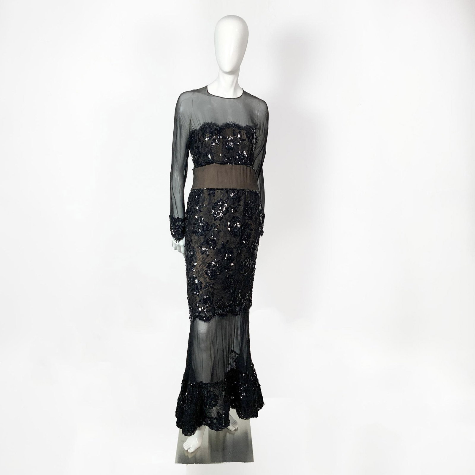 Scaasi Neiman Marcus Black Long Sleeved Sheer Sequined Dress: A vintage long sleeved sheer dress with black sequined lace over nude fabric, that follows to the cuffs and hem. Size: 10. Bust: 16"W. Waist: 14"W. Sleeve length: 23"L. Full length: 56.5"L. All measur