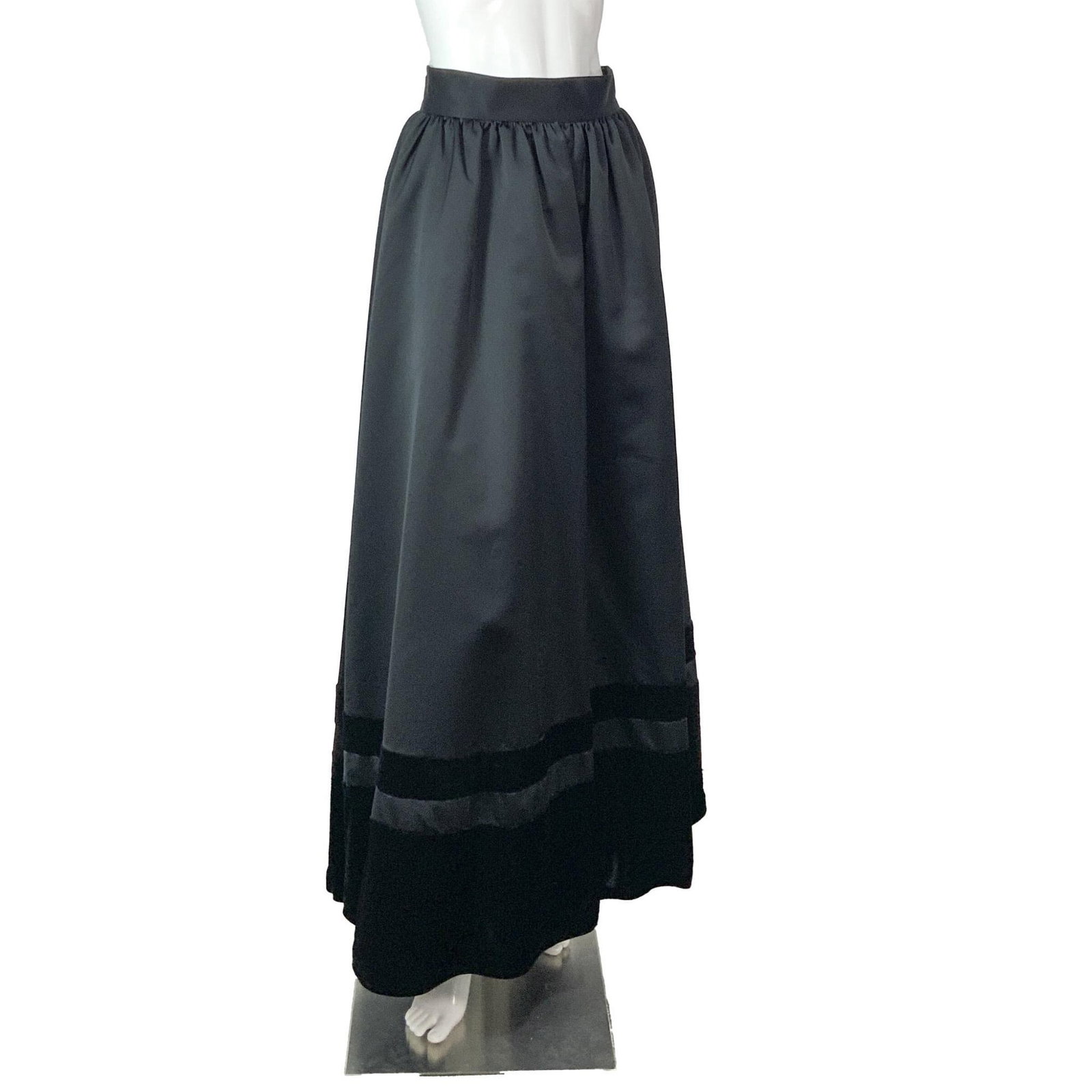 Black Tie Oleg Cassini Neiman Marcus Black Long Skirt: An exquisite long black satin pleated skirt featuring a velvet trim along the hem. Size: 8. Waist: 13"W. Length: 42"L. All measurements are approximate. Issued: c. 1980 Dimensions: See Description Pro