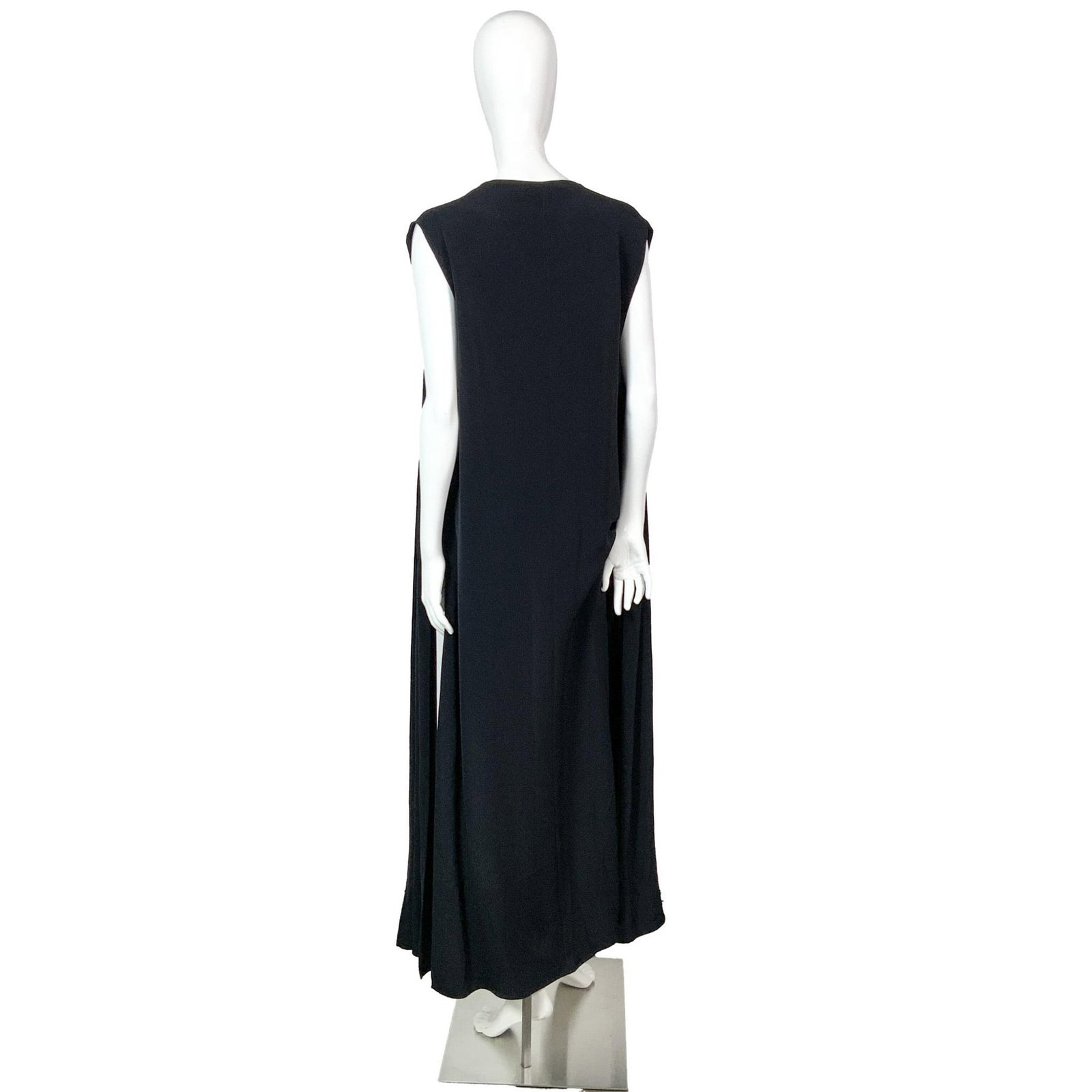 Genny Oro Black Sleeveless Duster: An elegant, black sleeveless duster, with slits on each side. Size: 10. Bust: 18"W. Full length: 52"L. All measurements are approximate. Issued: c. 1980 Dimensions: See Description Provenance: