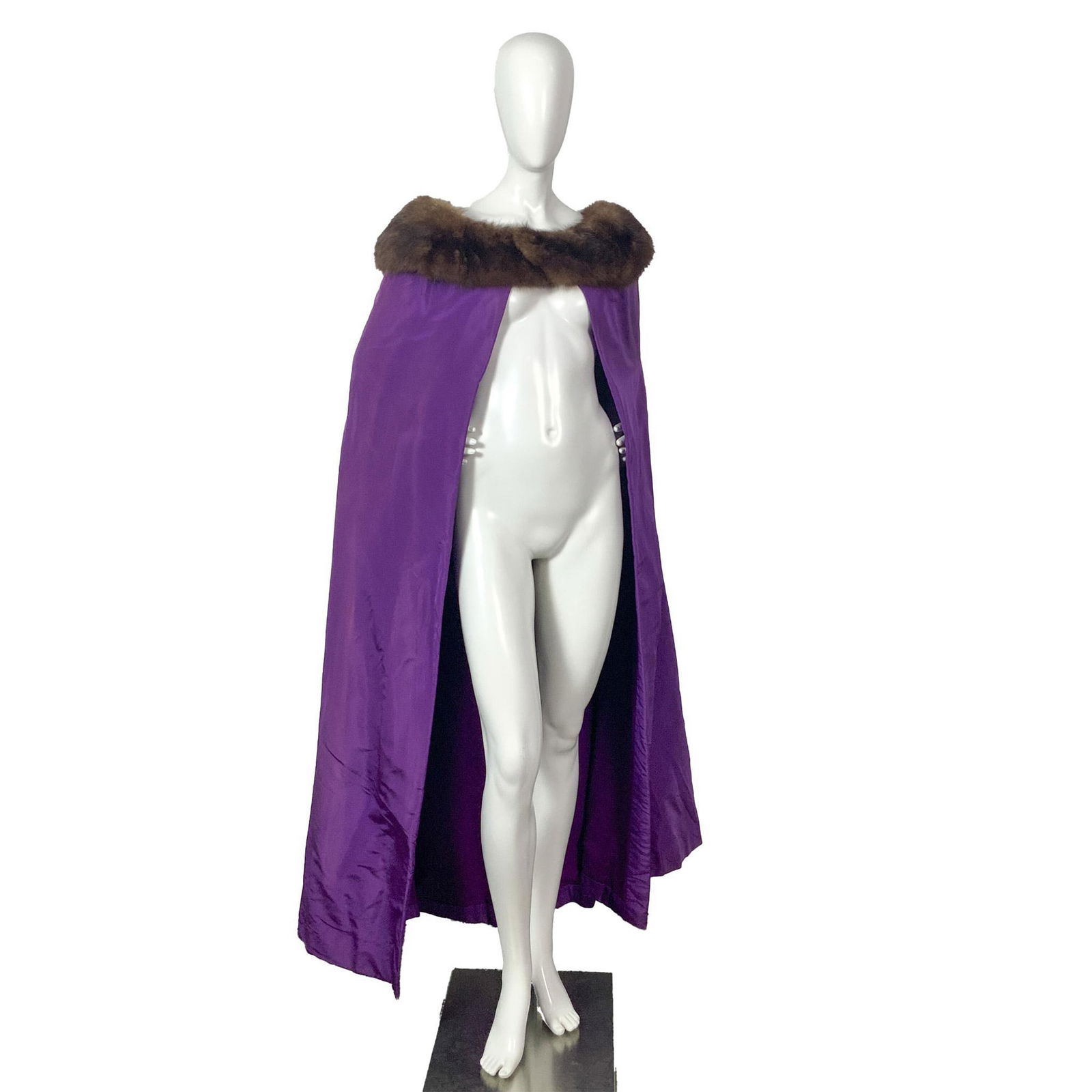 Pauline Trigere Purple Cape with Mink Fur Collar: A stunning vintage bright purple cape with mink fur along the collar. Shoulder length: 20"W. Full length: 55"L. All measurements are approximate. Issued: c. 1980 Dimensions: See Description Provenance