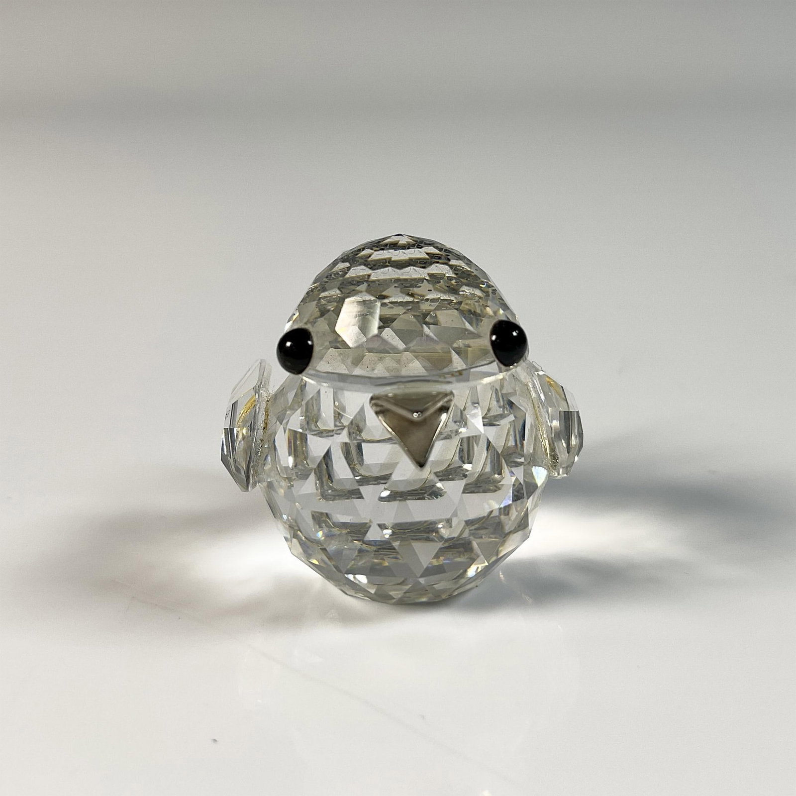 Swarovski Crystal Figurine, Sparrow: Adorable sparrow figure crafted from clear crystal with intricate cut design. Swarovski swan mark. This item includes an original box: 2.5"W x 3"H. 010017. Artist: Max Schreck Issued: 1979-1991 Dimens