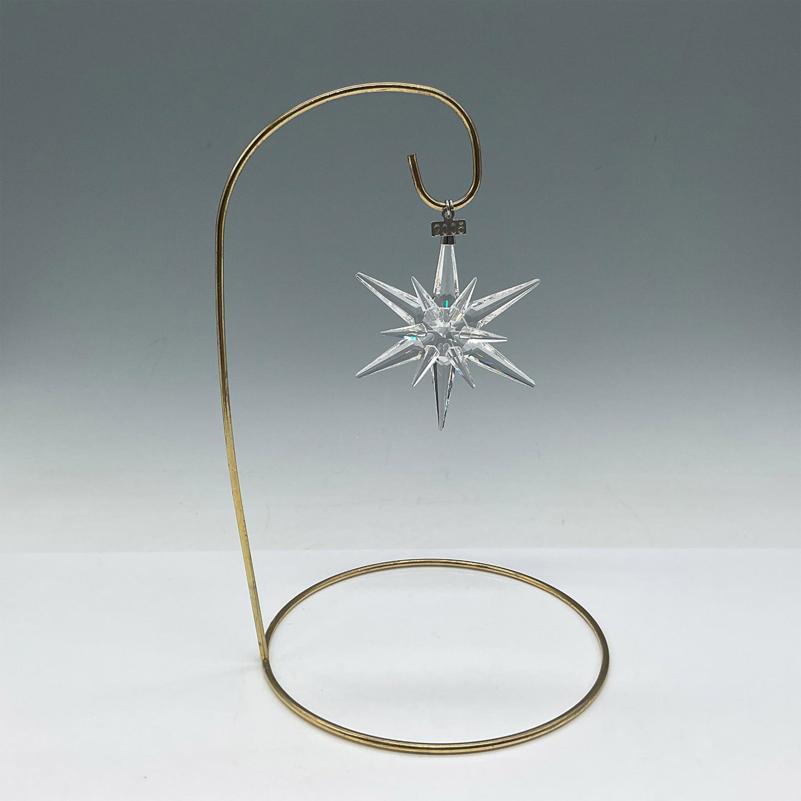 Swarovski Crystal 2005 Holiday Ornament: Stunning crystal star with engraved date tag. Swarovski backstamp. Artist: Martin Zendron Issued: 2005 Dimensions: 3"L x 3"W Manufacturer: Swarovski Country of Origin: Austria