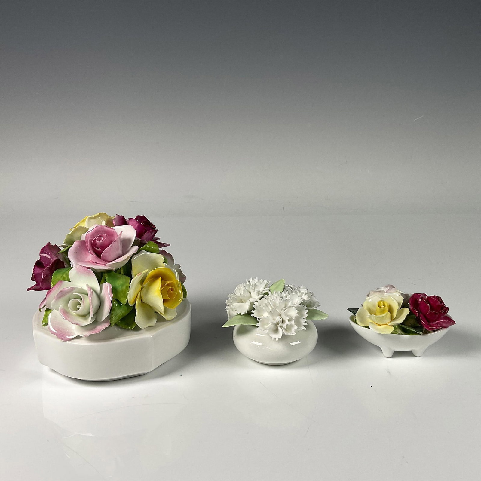 3pc Bone China Bouquet Vase: Hand painted and hand decorated collection featuring three elegant vases each has beautiful blooming flowers. The largest vase with yellow, purple and white roses including Royal Sutherland backstamp: