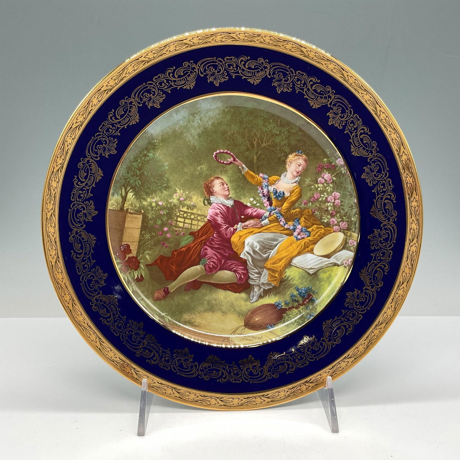 Limoges Royal Blue Porcelain Display Plate, Courting Scene: Lovely deep blue plate with gilt rim and vine design over blue. Center is designed with French courting scene. FM Limoges backstamp. Issued: 20th century Dimensions: 10" dia. Country of Origin: France
