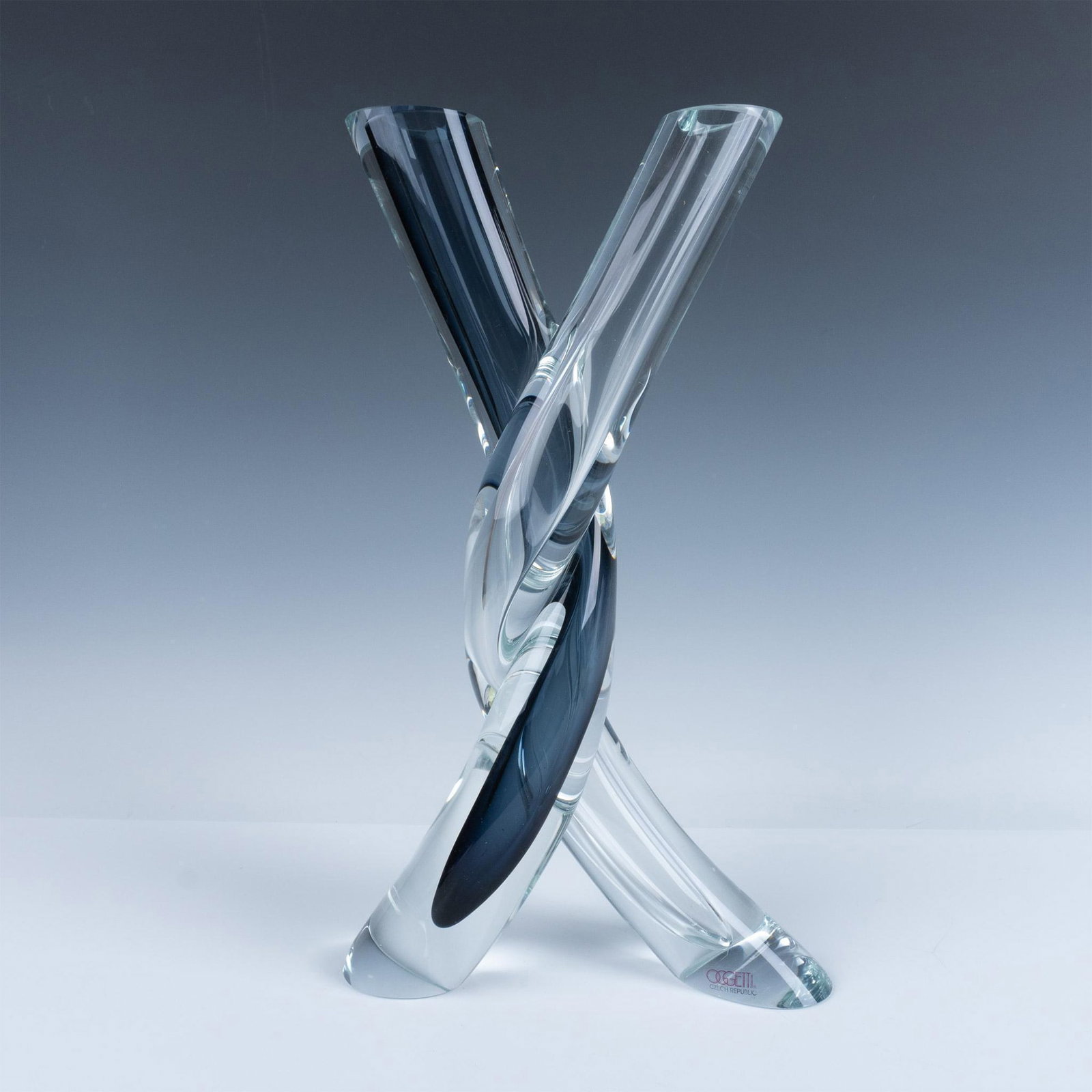 Oggetti Handmade Art Glass Twisted Double Vase, Signed: Stunning vase made from blue and clear glass. Artist signature etched on the bottom. Artist: Jan Konarik Dimensions: 9.15"L x 3.25"W x 16"H Manufacturer: Oggetti