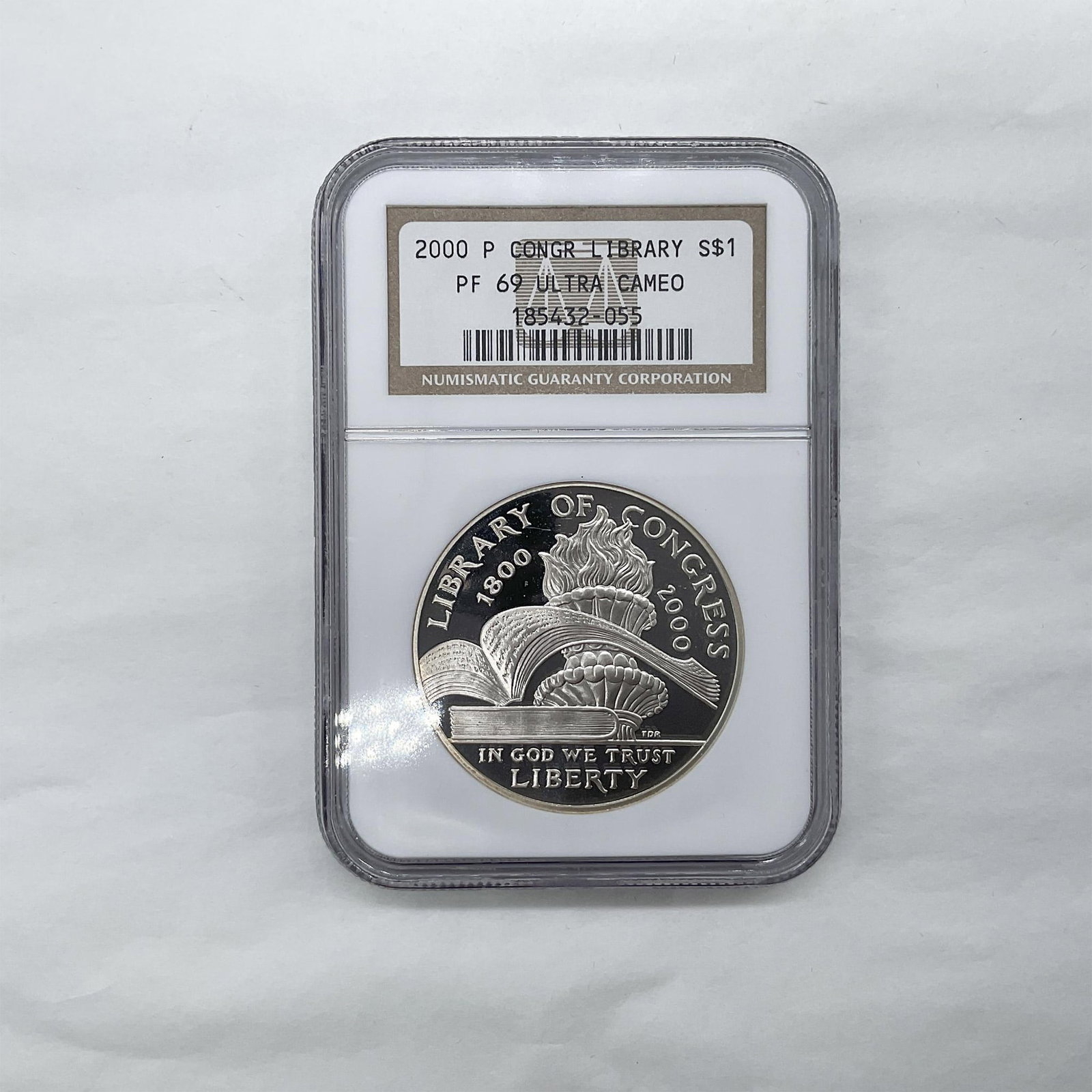 2000-P US Library of Congress Silver Dollar PF69 UCAM NGC: Philadelphia Mint. Graded PF69 Ultra Cameo. The obverse side depicts two books, one is open with its spine resting on the other closed book. The torch of learning appears in the background. The revers