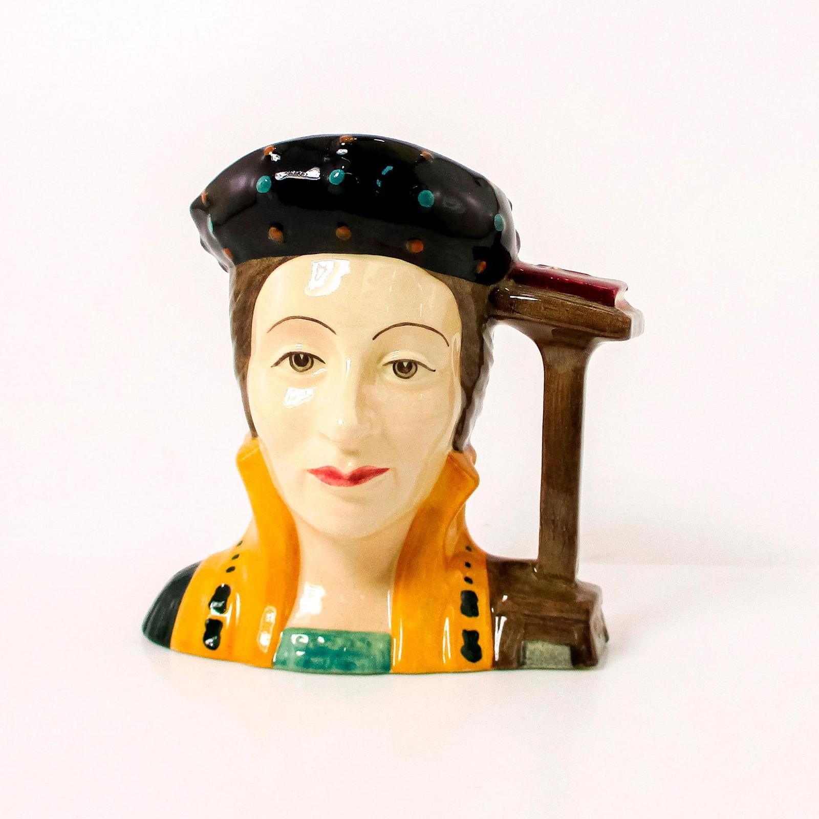 Catherine Parr D6751 - Small - Royal Doulton Character Jug: Style One, bible and pulpit handle. Black, brown and gold coloration. Catherine Parr (1512 - 1548) became Henry VIII's last wife on July 12, 1543, after being twice widowed. She came to wield consider
