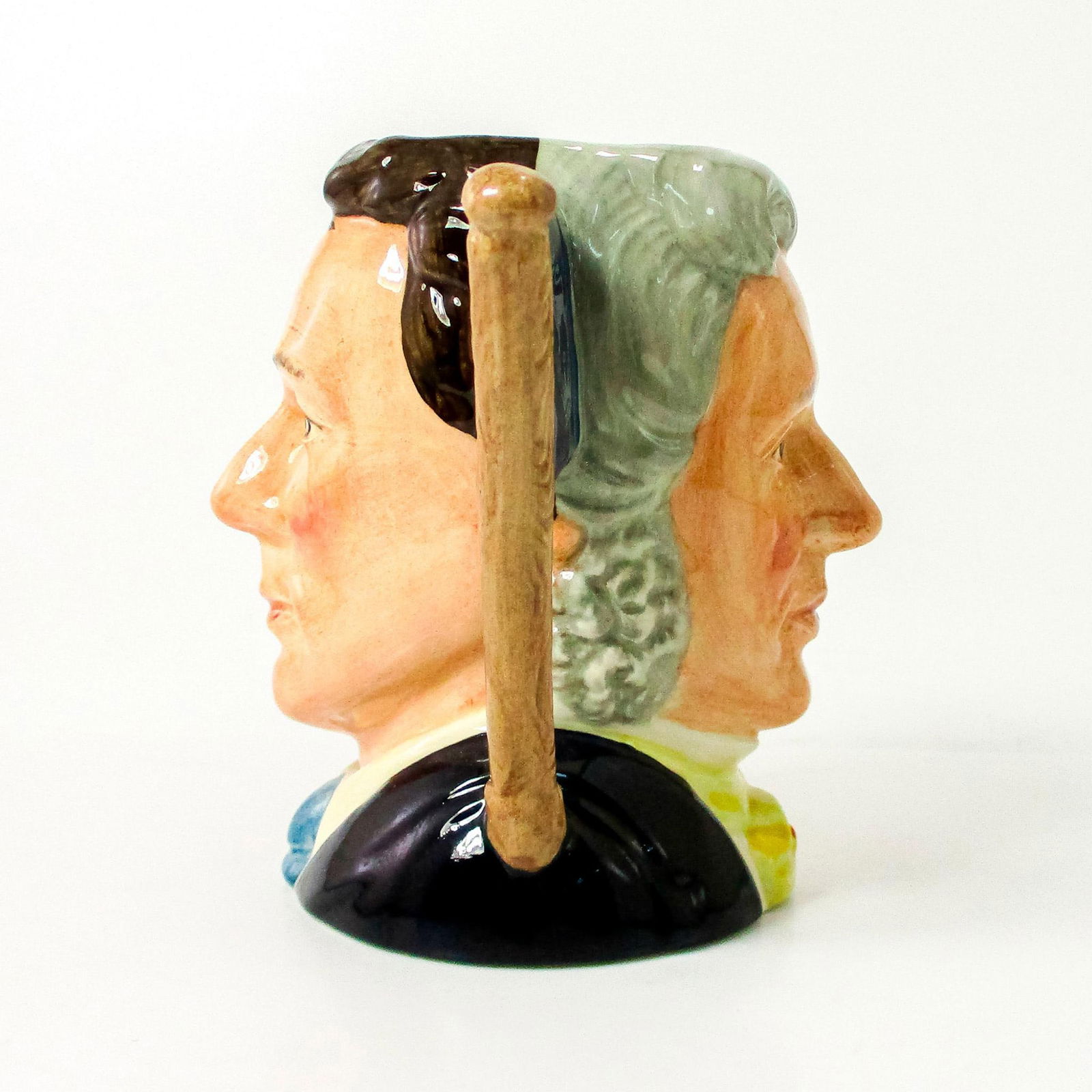 Sir Henry / Michael Doulton D6921 - Small - Royal Doulton Character Jug: Henry- Grey hair; yellow cravat; Michael- Brown hair; dark blue suit; white shirt; light blue tie. Signed. This two-faced jug was a special edition jug issued to mark Michael Doulton's personal appear