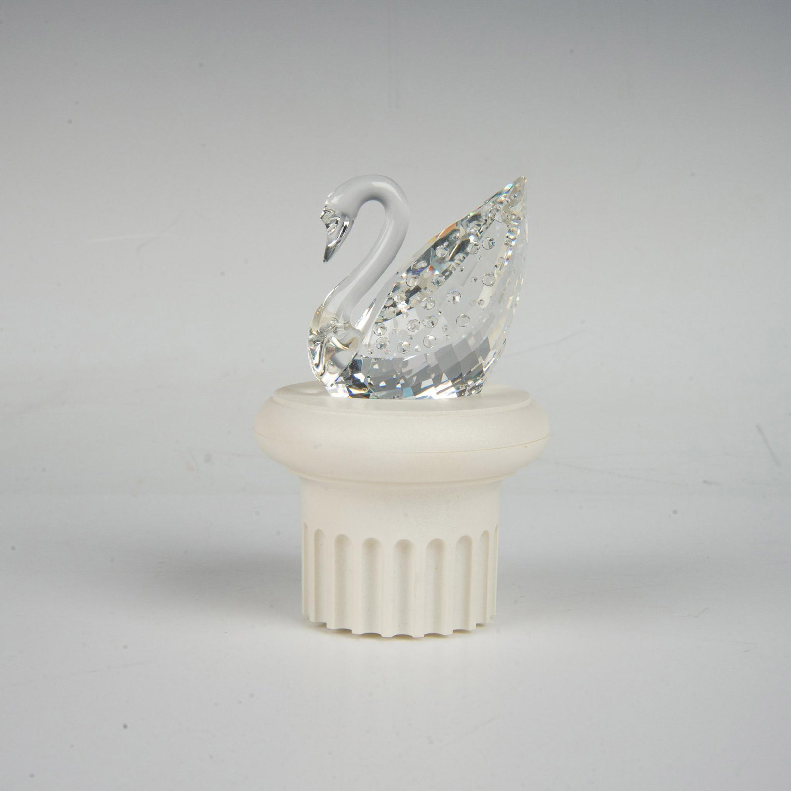 Swarovski Silver Crystal Figurine, 1995 Centenary Swan 18740: A clear faceted figure of an elegant long-necked bird adorned with 100 small crystals, to commemorate the 100th year anniversary. Swarovski marking. This item has its original box and a base included.