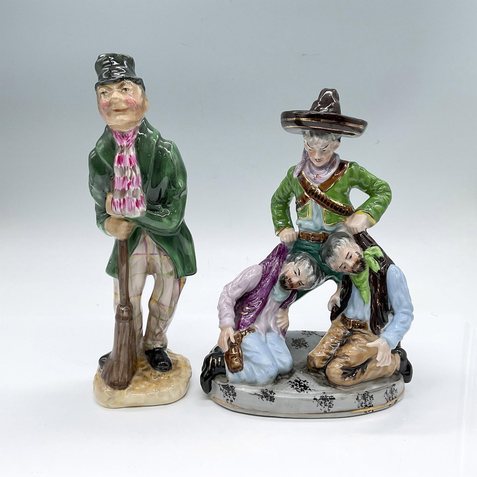 2pc English Bone China and Japanese Porcelain Figurines: Vintage hand painted figures with high glazing. Collection includes bone china Ricard Studio Products titled London Crossing Sweeper, and a porcelain figure from occupied Japan that depicts a man stop