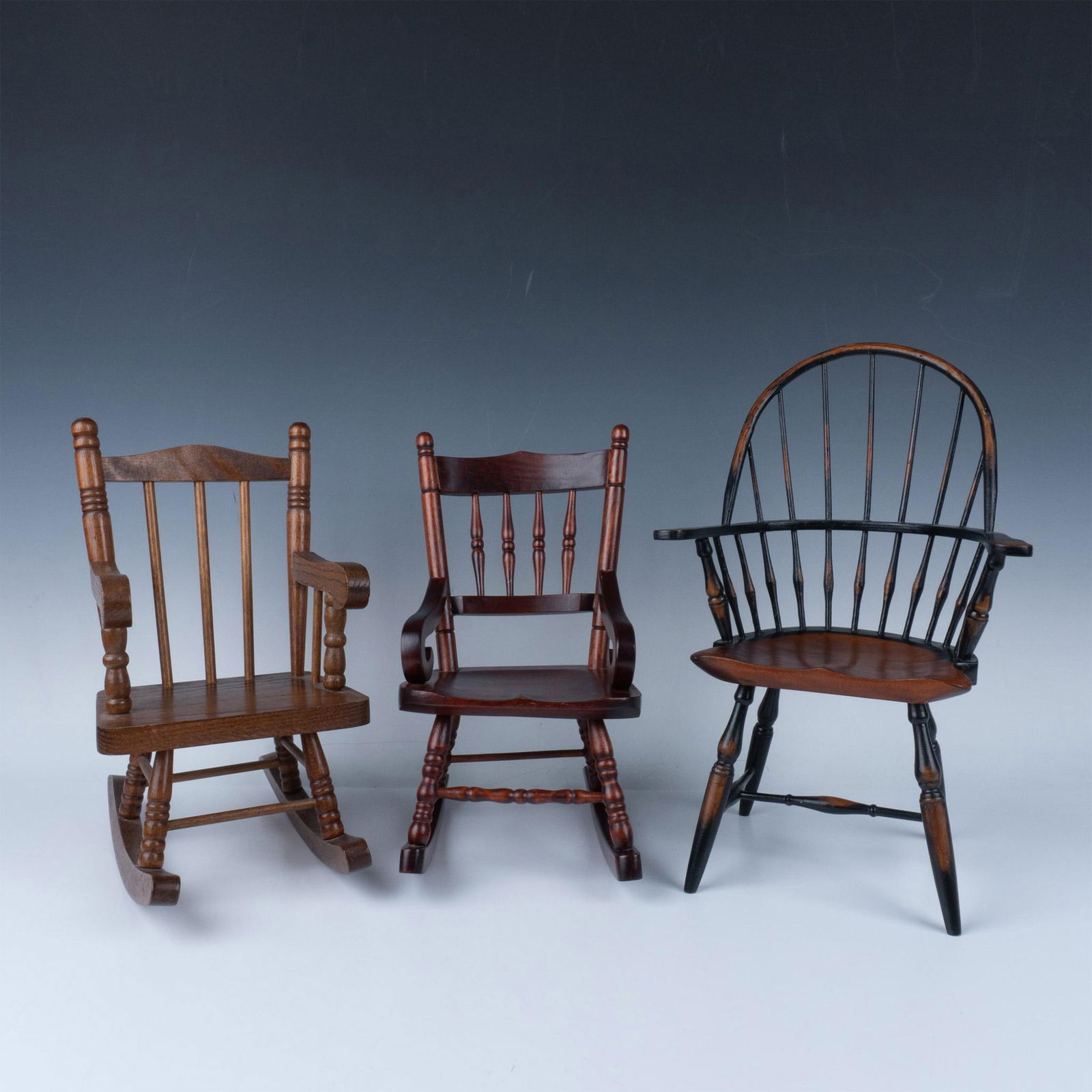 3pc Wooden Doll Furniture, Rockers and Spindle Back Chair: Lot includes high spindle back chair 9.25"L x 6.5"W x 14.5"H, Mahogany rocking chair 6.25"L x 9"W x 12"H and oak rocking chair 7"L x 10.5"W x 12.5"H. Three Hands Corp sticker. Issued: 20th century Dim