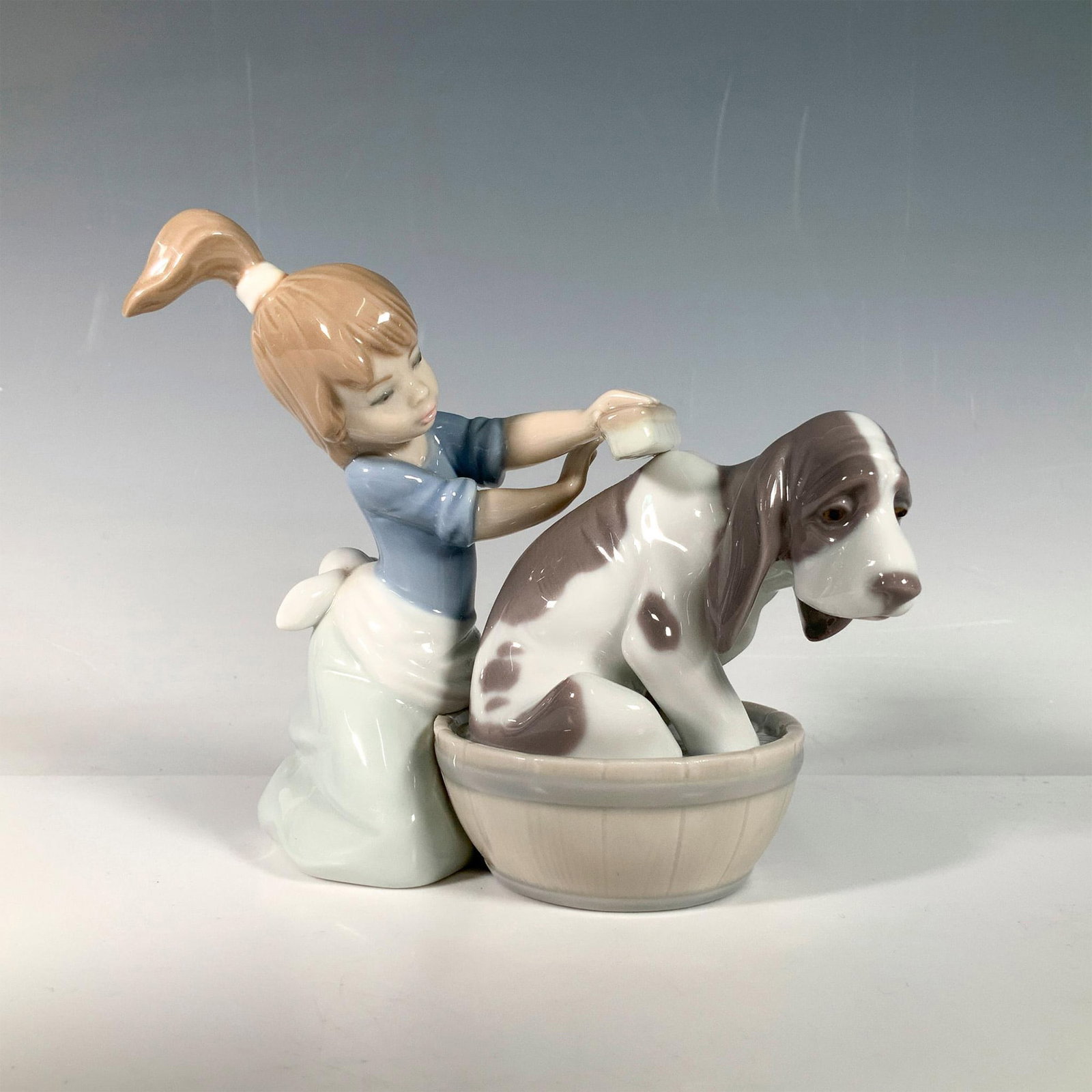 Bashful Bather 1005455 - Lladro Porcelain Figurine: Glossy finish; Lladro backstamp. Artist: Juan Huerta Dimensions: 5.5"L x 2.75"W x 5"H Manufacturer: Lladro Country of Origin: Spain