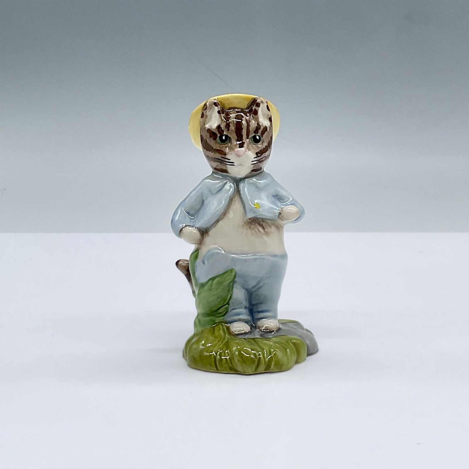 Beswick Beatrix Potter Figurine, Tom Kitten In The Rockery: Glossy porcelain. Features a cat with a hat standing over a patch of grass. Beswick Beatrix Potter backstamp. This item has its original box, dimensions: 3"L x 3"W x 4.25"H. Issued: 1997 Dimensions: 2
