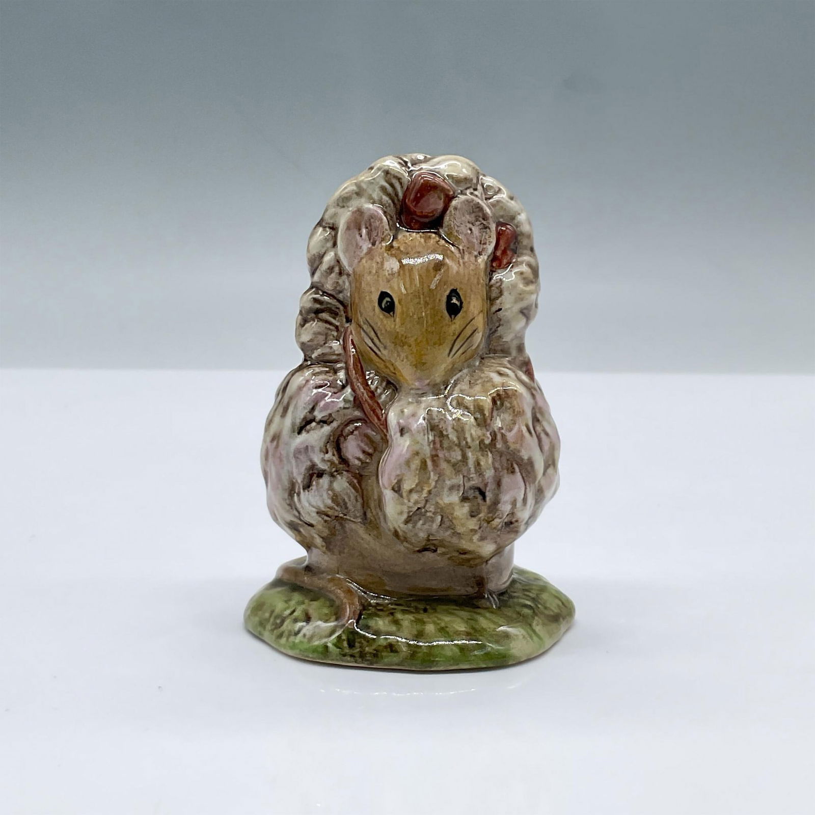 Beswick Beatrix Potter Figurine, Tomasina Tittlemouse: Glossy porcelain. Features a mouse wearing a coat and a bow on her head. Beswick, F Warn & Co. Beatrix Potter copyright backstamp. This item has its original box, dimensions: 3"L x 3"W x 4.5"H. Issued
