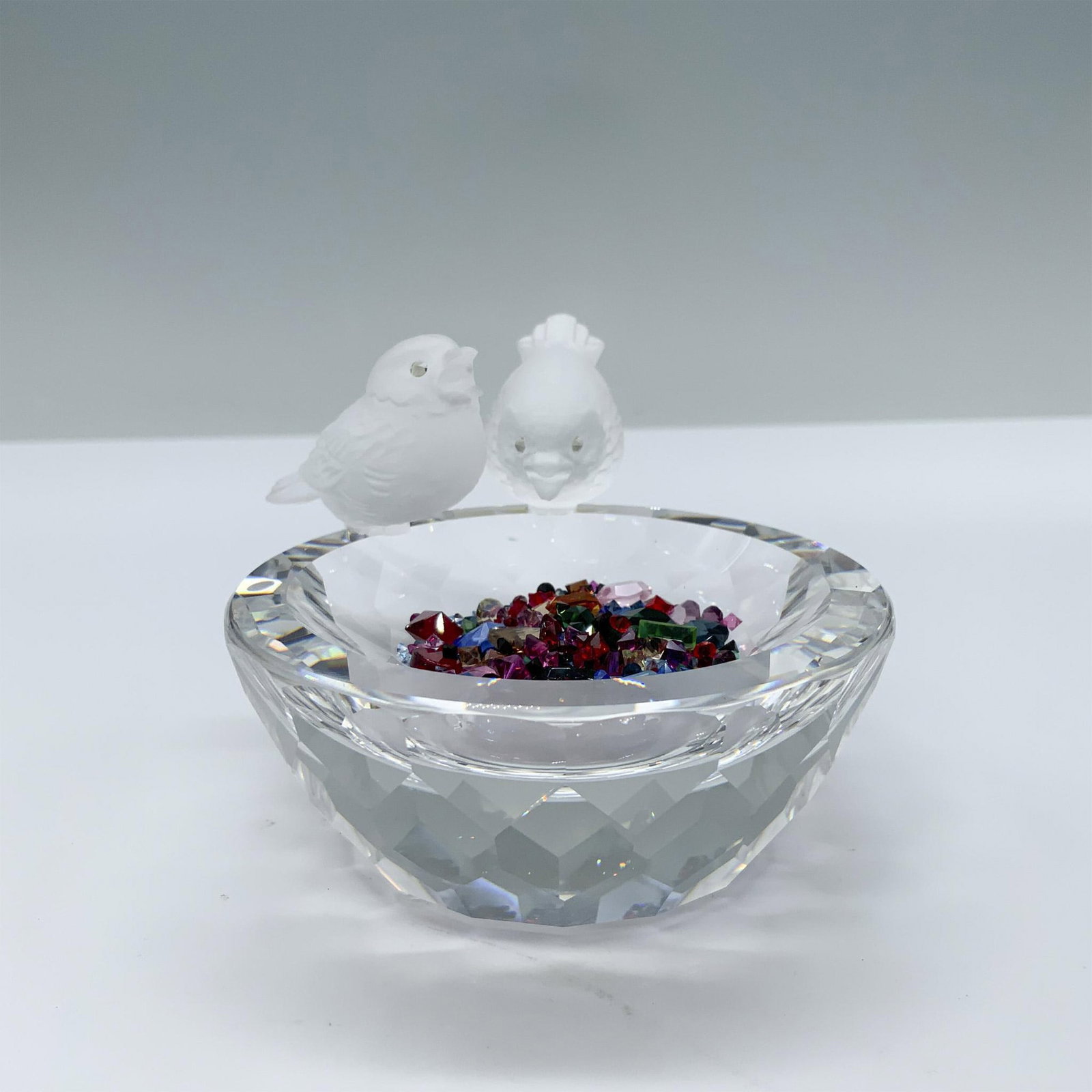 Swarovski Crystal Figurine, Bird Bath with Crystals: Two frosted birds perched on edge of crystal bath looking at loose crystals. Swarovski swan mark. 010029. This item has its original box. Box measures: 4.75"H x 6" dia. Artist: Max Schreck Issued: 198