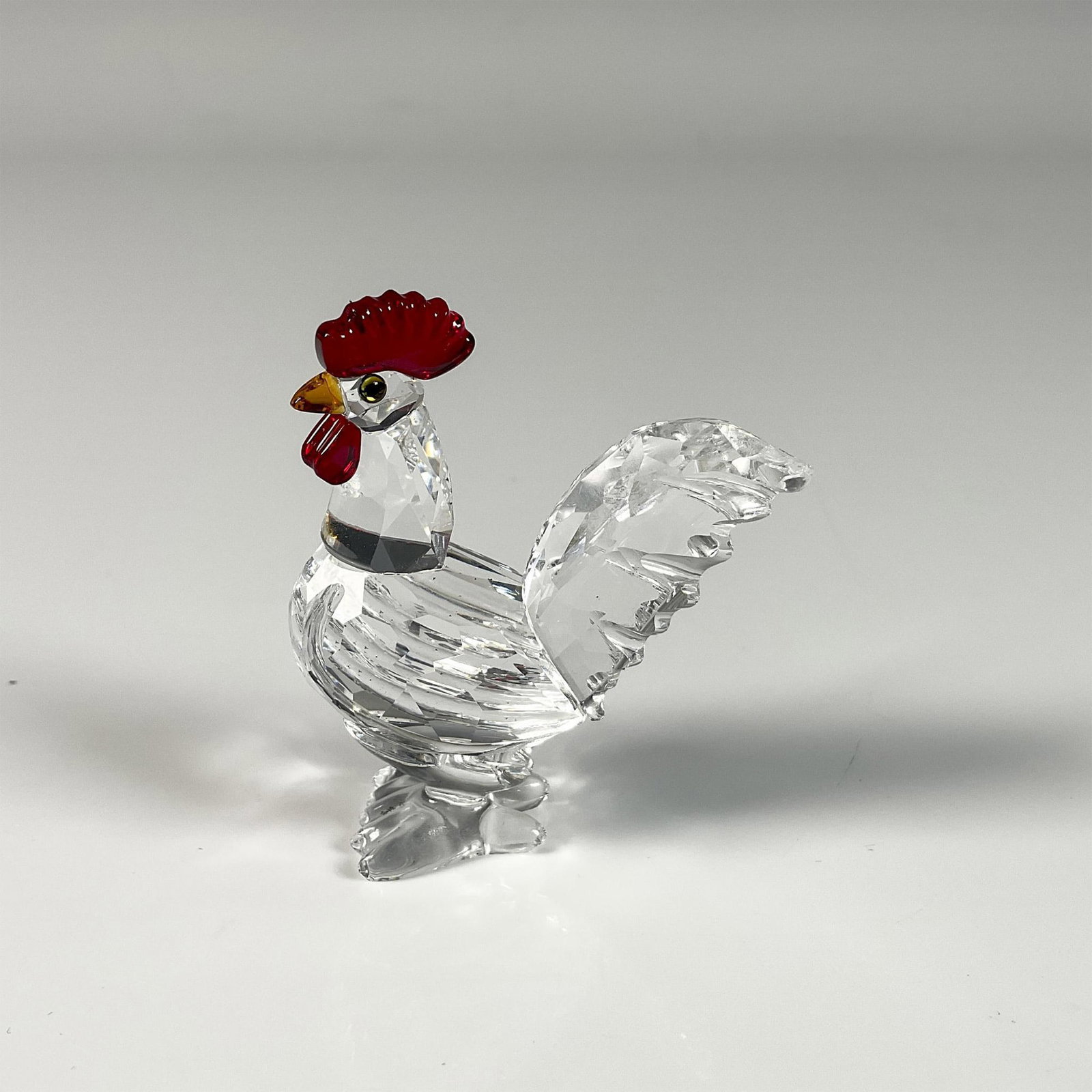 Swarovski Crystal Figurine, Cockerel: Gorgeous clear crystal cockerel figure from the Peaceful Countryside theme group, with a red comb and green eyes. Swarovski swan mark. This item includes an original box: 3.25"W x 2.5"H. 247759. Artis