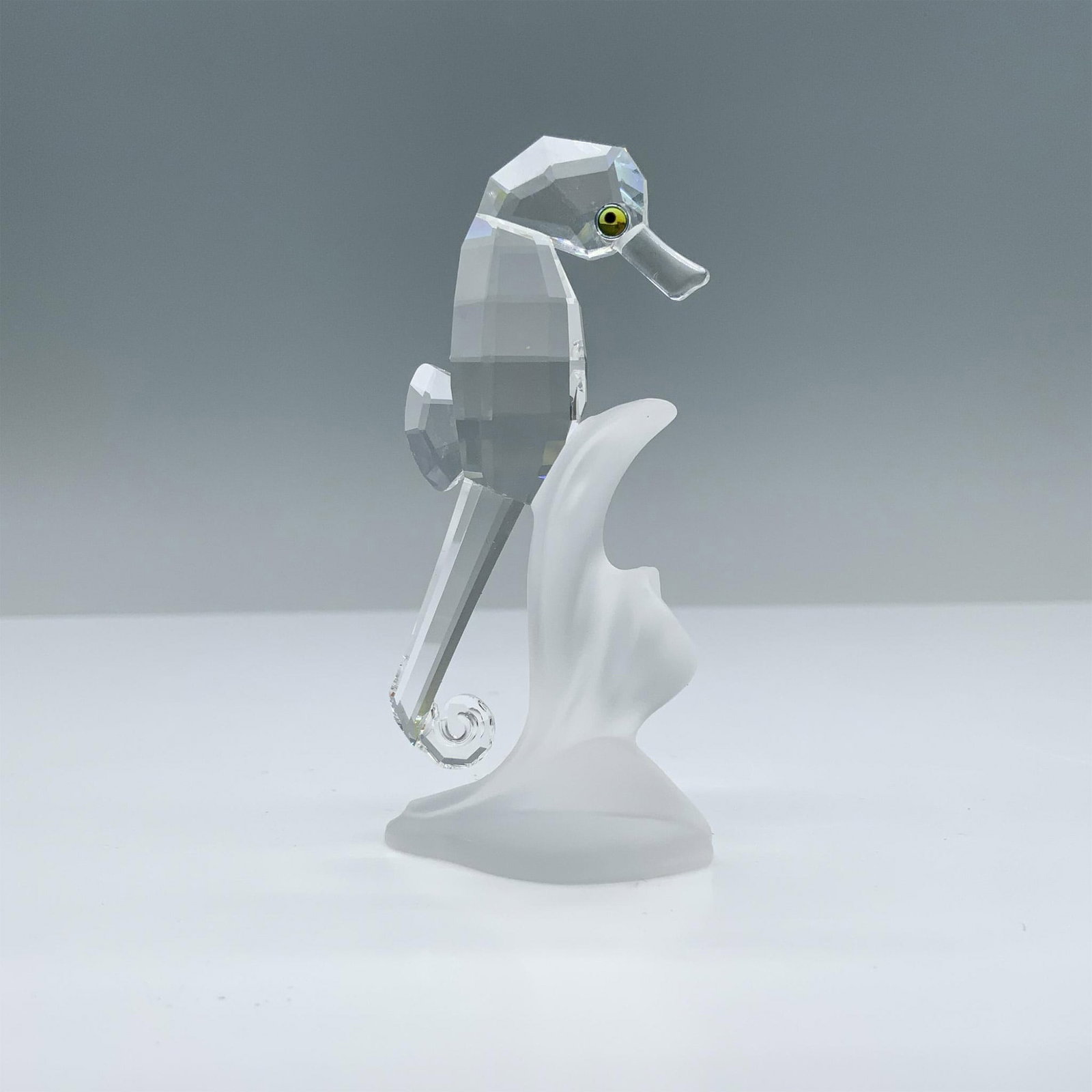 Swarovski Crystal Figurine, Sea Horse: Brilliant cut clear crystal figure of a seahorse on a base of frosted crystal. Swarovski swan mark. Includes original box. Box measures: 6.25"H x 3.25" dia. Artist: Michael Stamey Issued: 1993 - 2006 