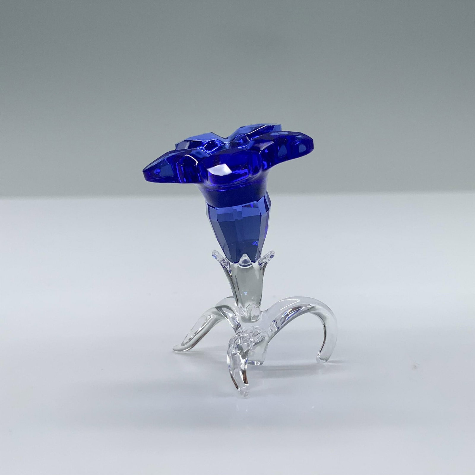 Swarovski Crystal Figurine, Gentian Flower Sculpture: Beautiful standing blue flower with bright yellow middle and crystal clear base. Swarovski swan mark. This item has its original box. Box measures: 3.75"L x 3.75"W x 1.25"H. 5490322. Issued: 2020 - 20