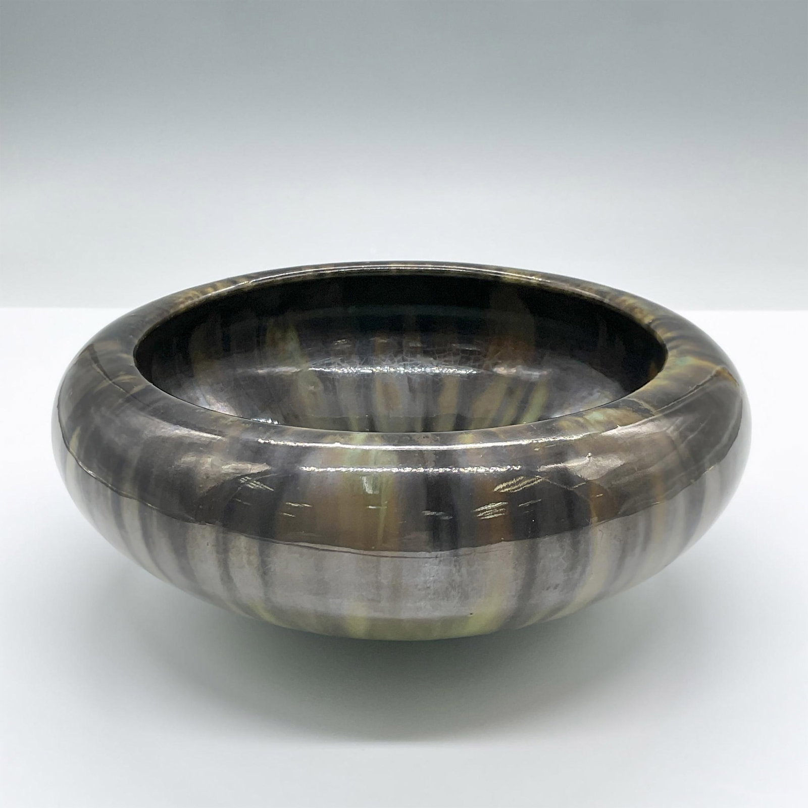 Fulper Art Pottery Low Bowl: This lovely glossy ceramic green bowl features a smeared brown glaze effect. Marked Fulper. Issued: 20th century Dimensions: 7.5"L x 7.5"W x 3"H Manufacturer: Felper Country of Origin: United States