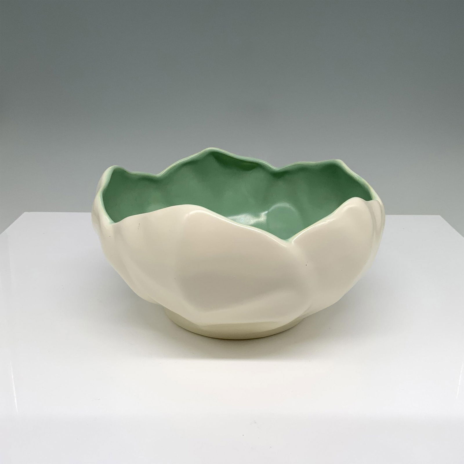 Catalina Pottery Salad Serving Bowl: Hand painted porcelain showcases a lettuce shaped deep bowl. Catalina impressed mark. C337. Marked made in USA. Dimensions: 4"H x 7.75" dia.