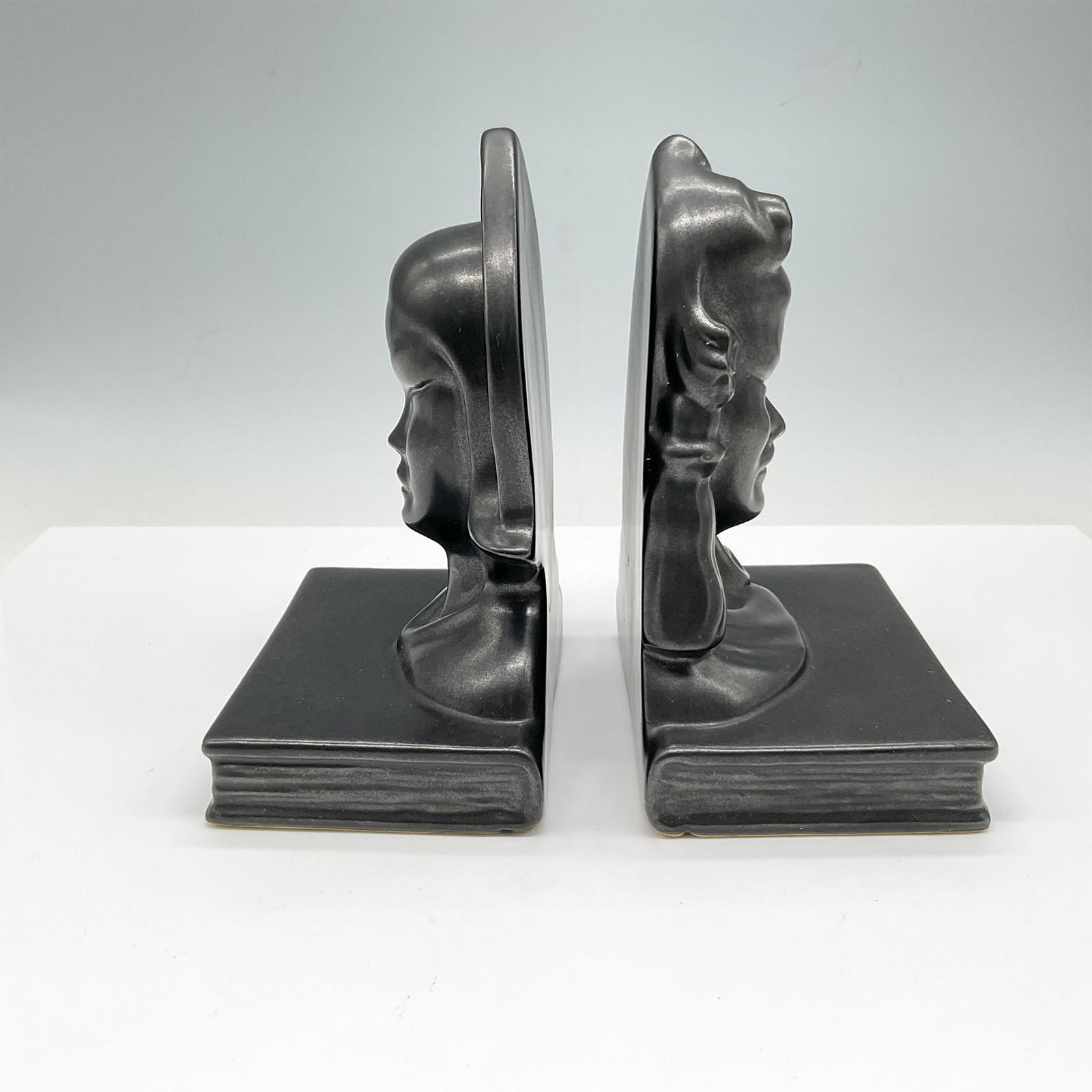 Pair of Roseville Pottery Black Burmese Bookends: Stoic male and female bust adorns these bookends. Roseville USA raised mark. 71 & 81B. Issued: c. 1950 Dimensions: 5"L x 3.5"W x 6.75"H Manufacturer: Roseville Country of Origin: United States
