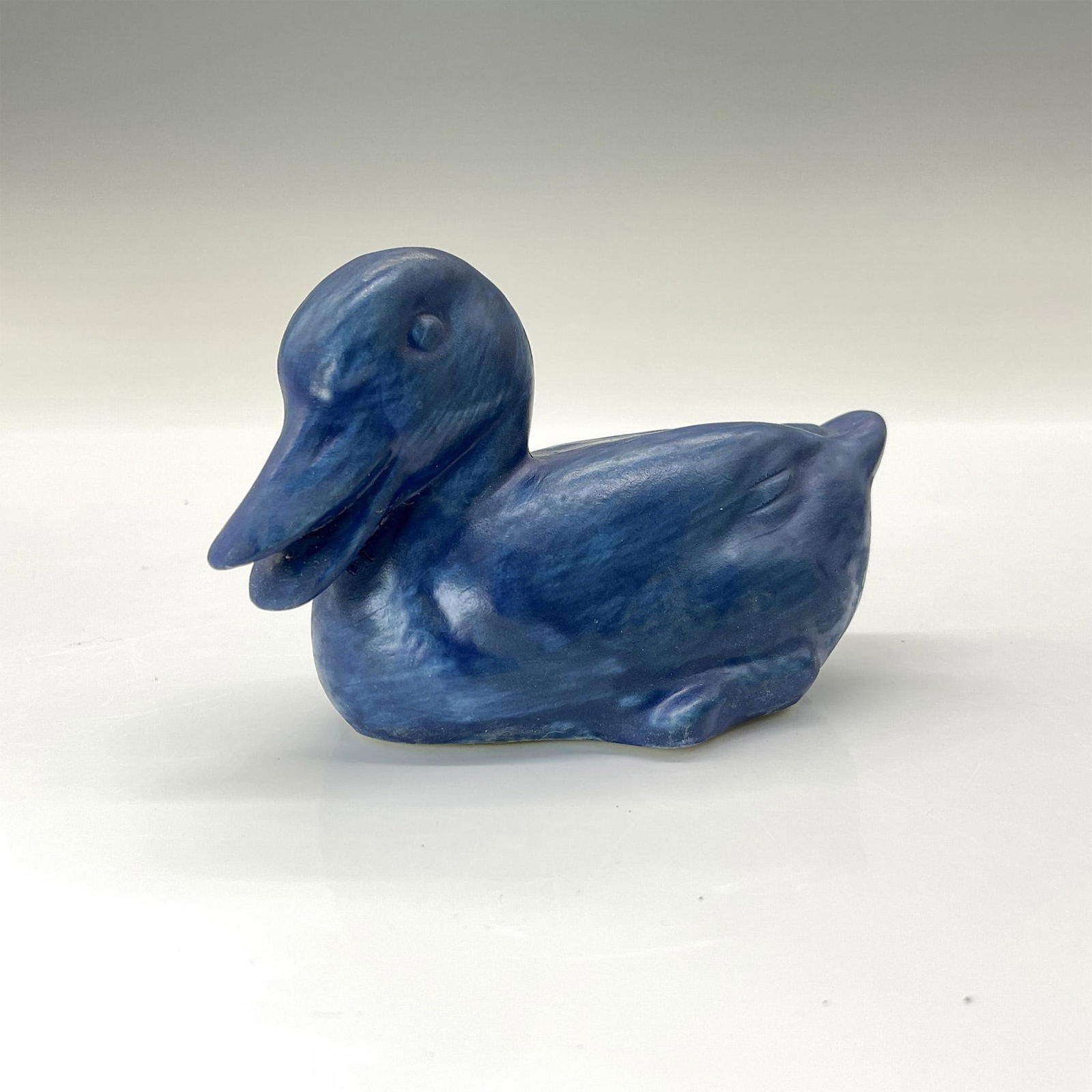 Rookwood Present Day Pottery Animal Figurine, Blue Duck: Precious duck crafted from the original master mold #6064 from 1945. Finished in a deep blue semi-matte glaze. Rookwood backstamp. This item has its original box that measures 5.75"L x 4.5"W x 3.5"H.