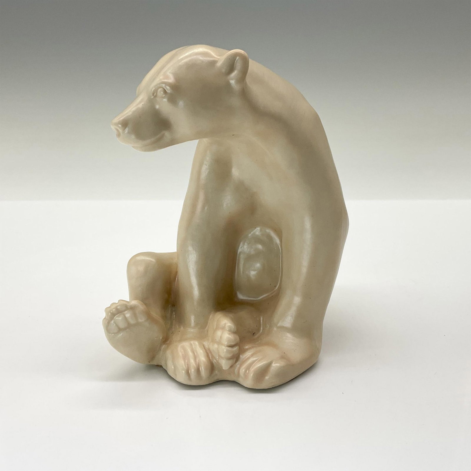 Rookwood Present Day Pottery Animal Figurine, White Bear: Charming seated bear crafted from the original master mold #6485 from 1945. Finished in a beautiful white with subtle pink undertones and a soft semi-matte glaze. Rookwood backstamp. This item has its