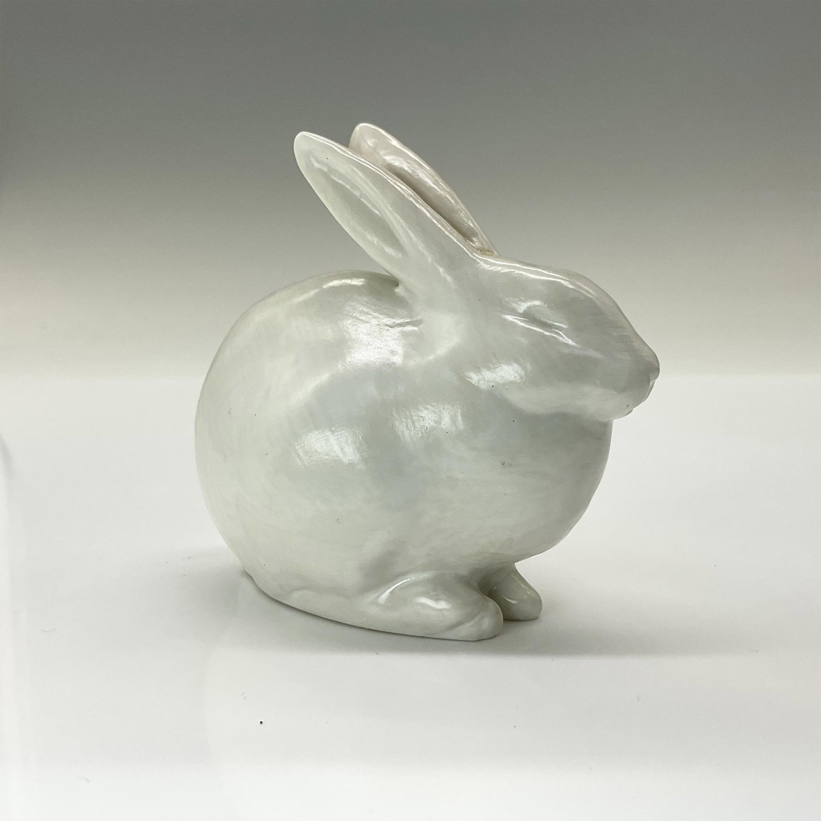 Rookwood Present Day Pottery Animal Figurine, White Rabbit: Adorable crouched rabbit crafted from the original master mold #6160 from 1928. Finished in a lovely white semi-gloss glaze. Rookwood backstamp. This item has its original box that measures 5.5"L x 4"