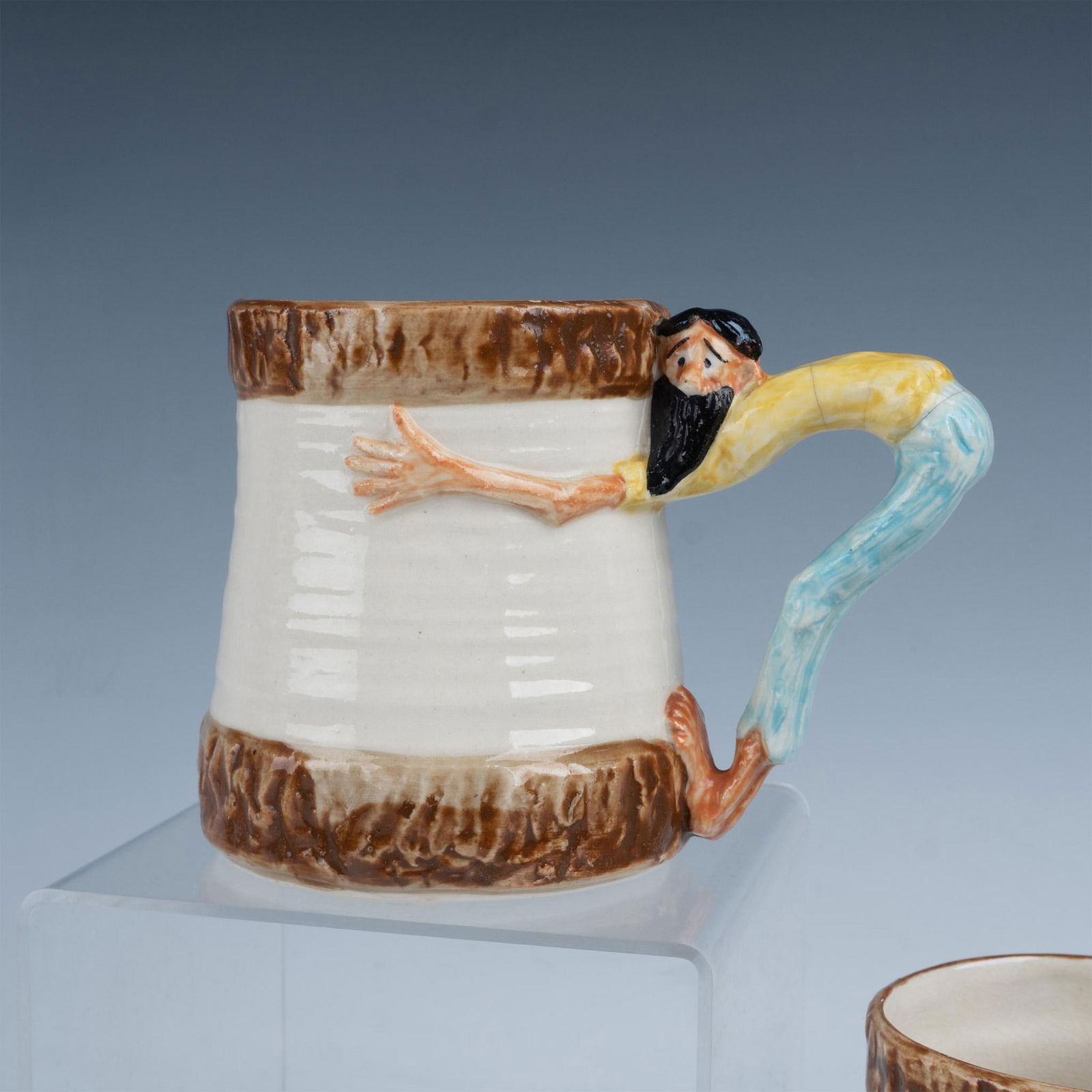 4pc Paul Webb Imperial Porcelain Mugs, Mountain Boys: A set of four mugs with cream colored bodies and a brown rim and base, each featuring a playful mountain man in a yellow shirt and blue jeans serving as the handle. Imperial Porcelain Corp backstamp.