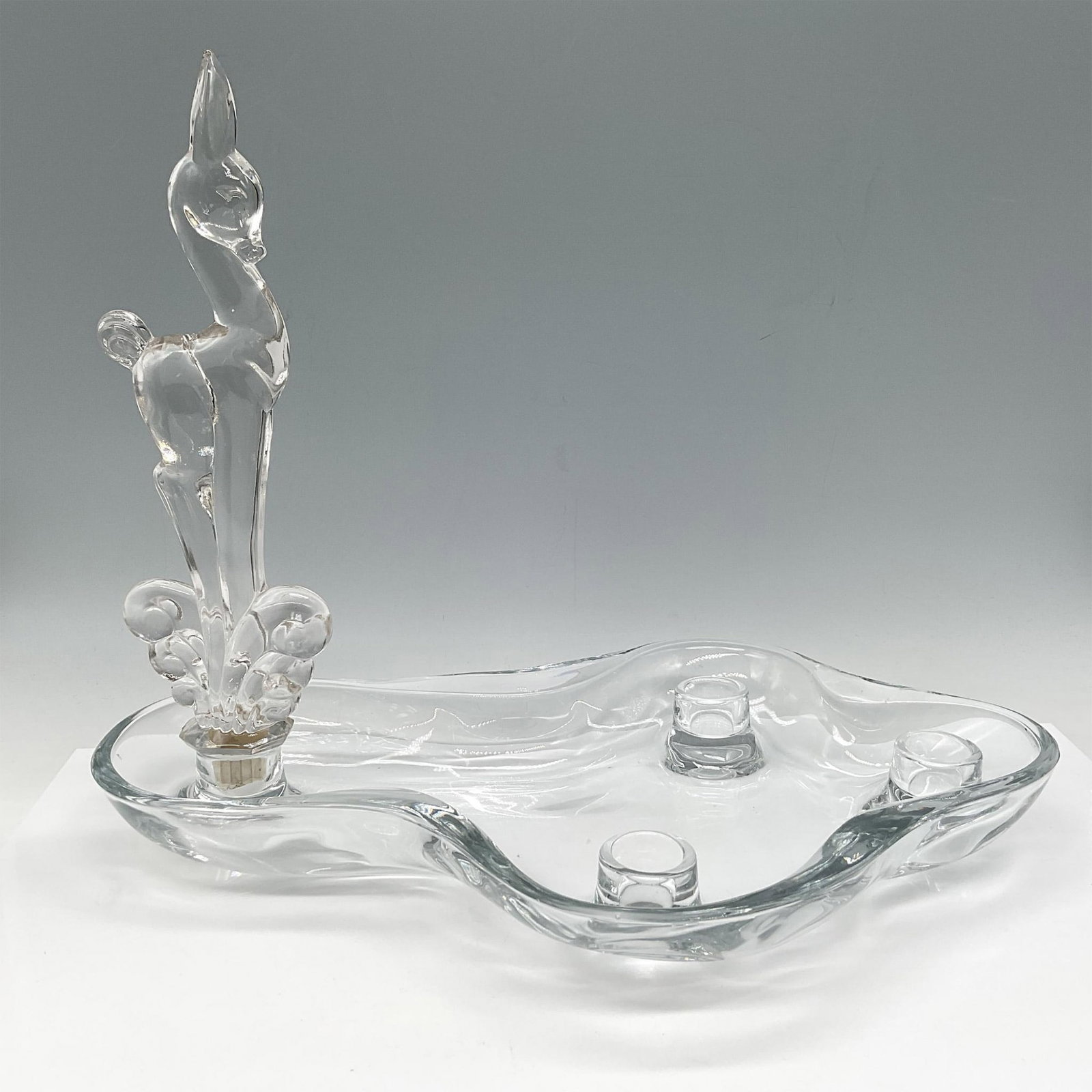 Rare Tiffin Glass Flower Floater Candle Holder with Fawn: Artistically designed clear glass holder has 4 insert spots for glass figure and candle sticks. Issued: c. 1948 Dimensions: 14.5"L x 9"W x 11.5"H Manufacturer: A.J. Beatty and Sons Country of Origin: 