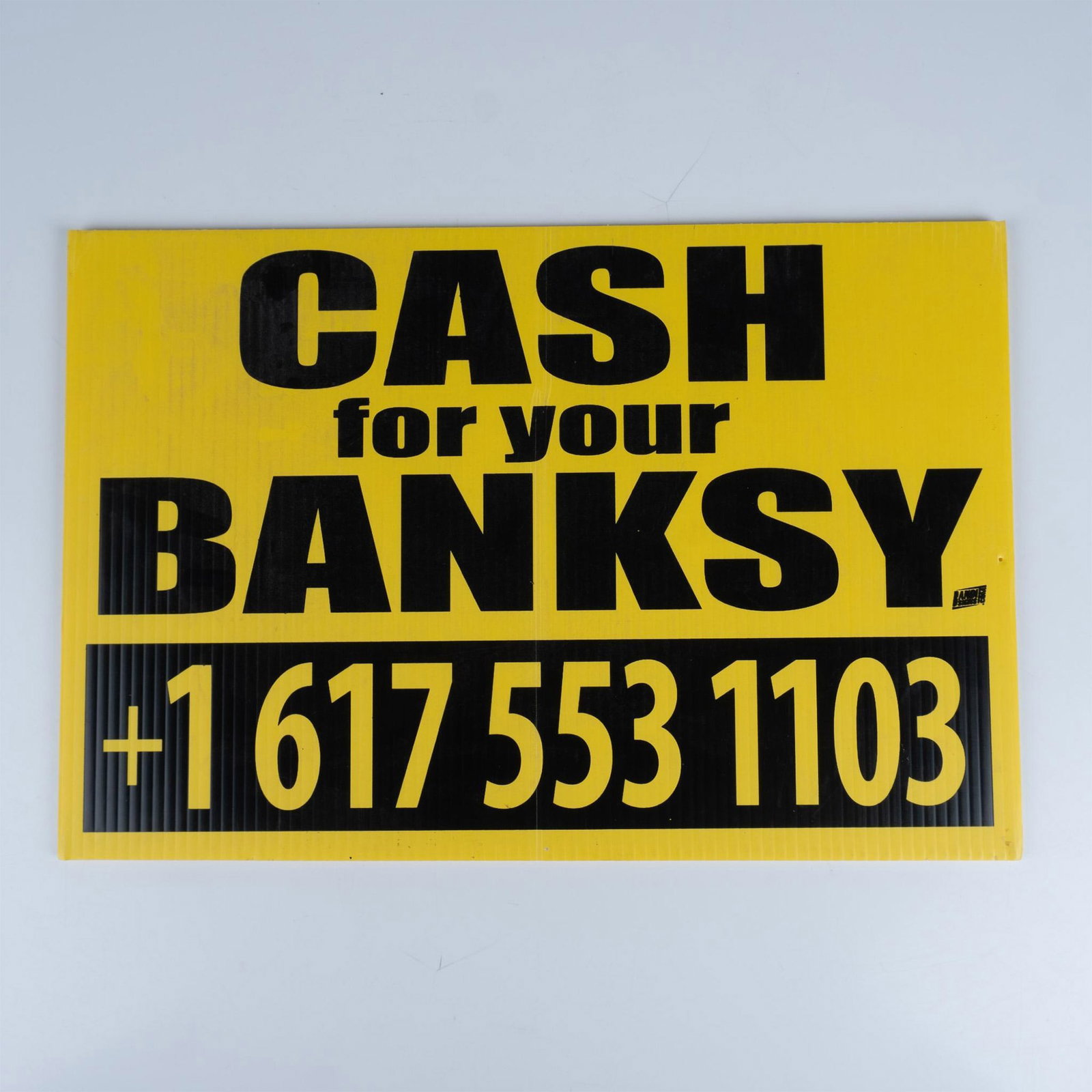 Street Artist Hargo's Cash for your Banksy Yellow Plastic Sign: Geoff Hargadon, a/k/a Hargo is well known for his "Cash for your Warhol" street sign series. Here he created a bold, vibrantly contrasted corrugated yellow plastic sign featuring advertisement for Cas