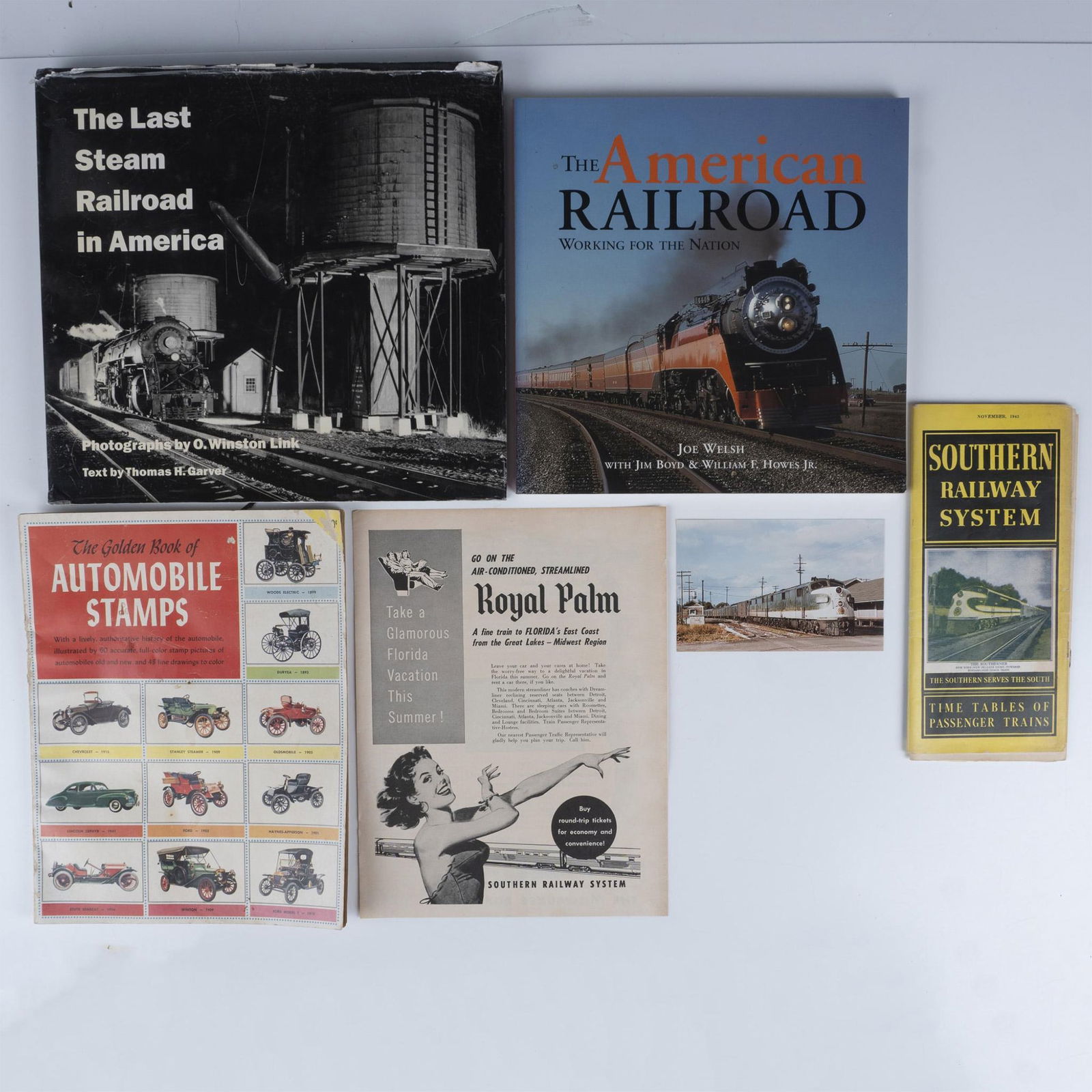 5 Railroad System Ephemera & Automobile Books: Titles include: The Last Railroad in America, by O. Winston Link and Thomas H. Garver (1995); The American Railroad: Working for the Nation by Joe Welsh (2006); The Golden Play Book of Automobile Stam