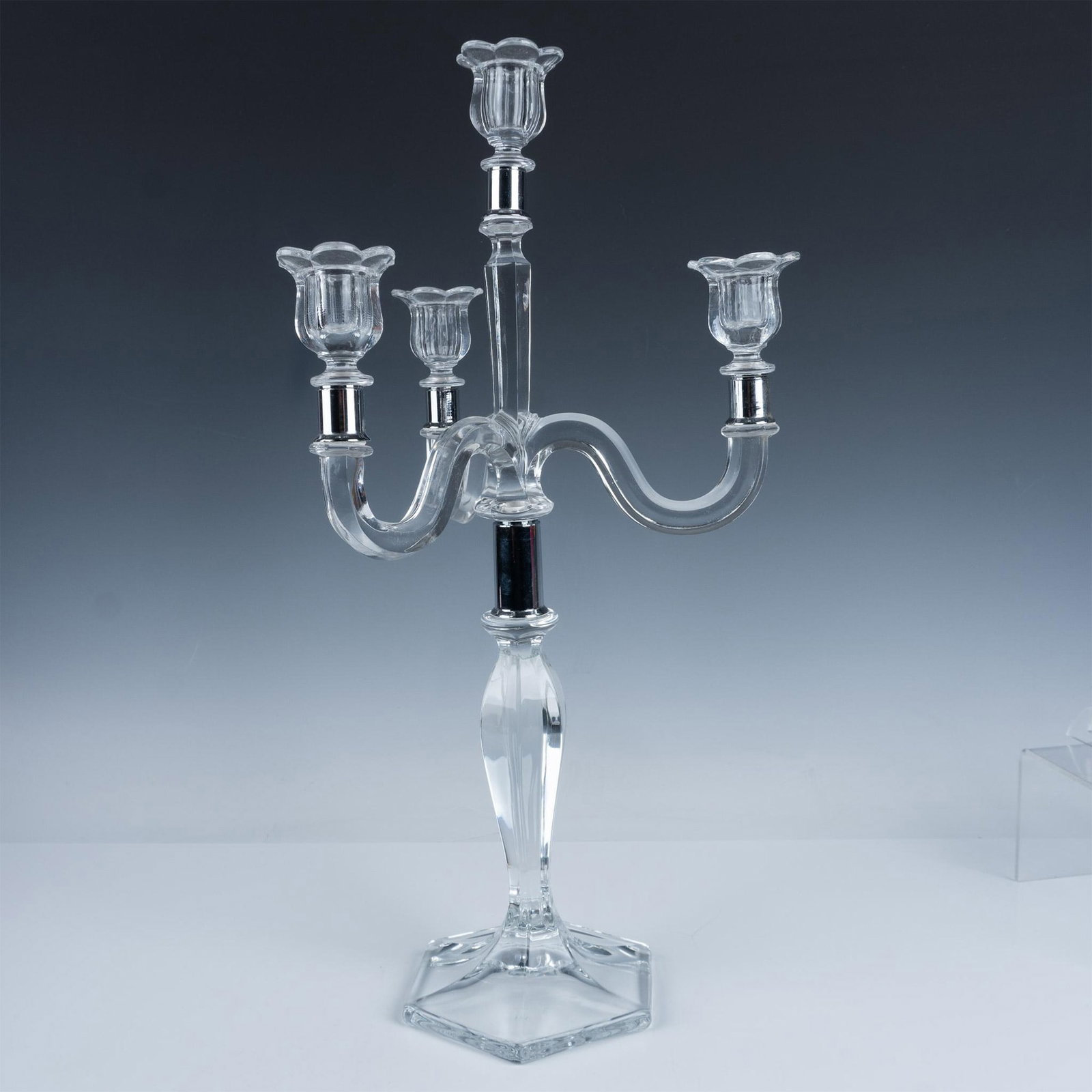 Fostoria Three Arm Detachable Candelabra: Stunning tall detachable candelabra with four detachable drip tray holders in the shape of flowers. Issued: 20th century Dimensions: 11.25"L x 11.25"W x 21.75"H Manufacturer: Fostoria Country of Origi