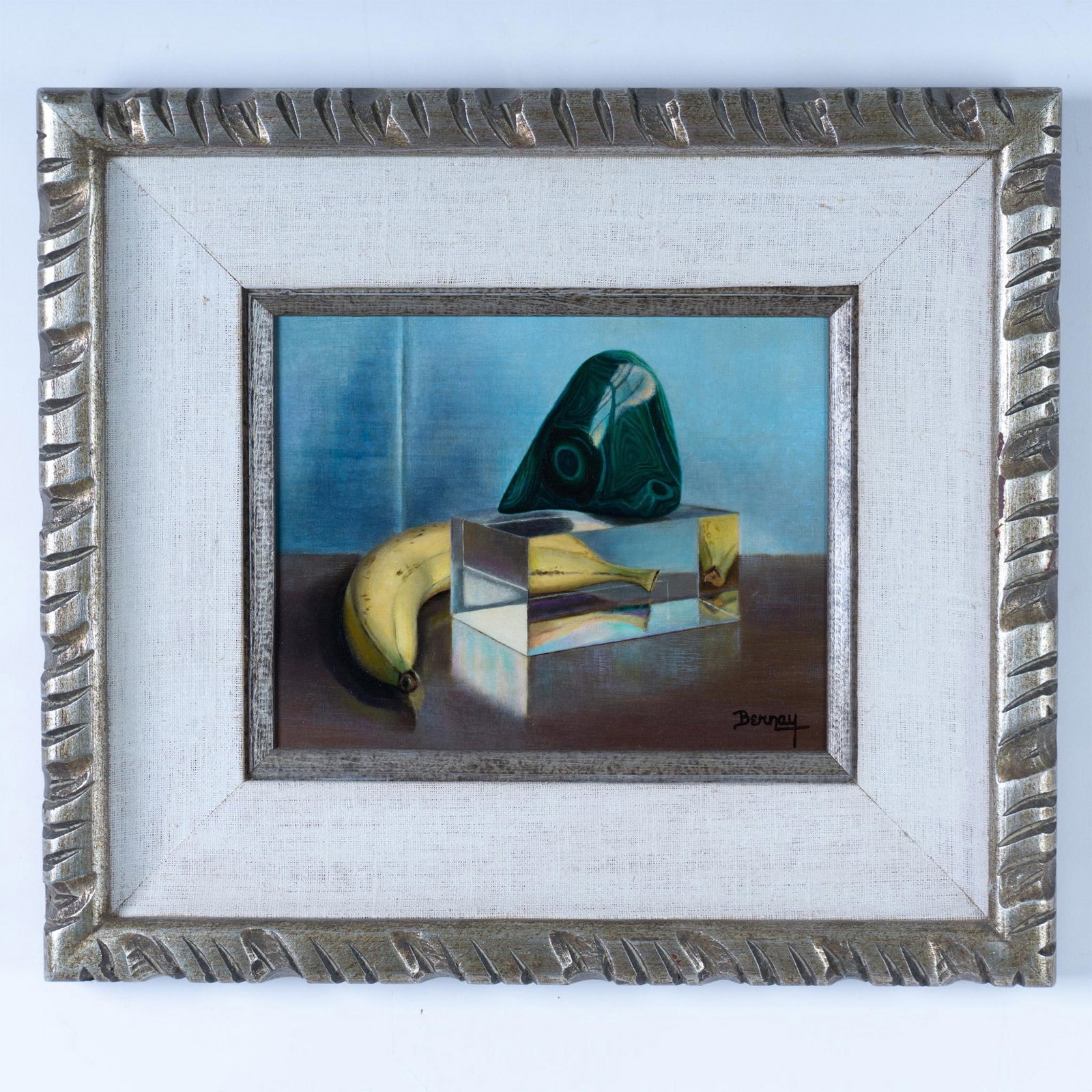 Betti Bernay, Original Oil on Masonite, Malachite, Signed: Original oil on Masonite made in a Precisionist style by American Realist artist Betti Bernay. She depicts a chunk of smooth malachite on a Lucite stand next to a banana that reflects in the edges. Si