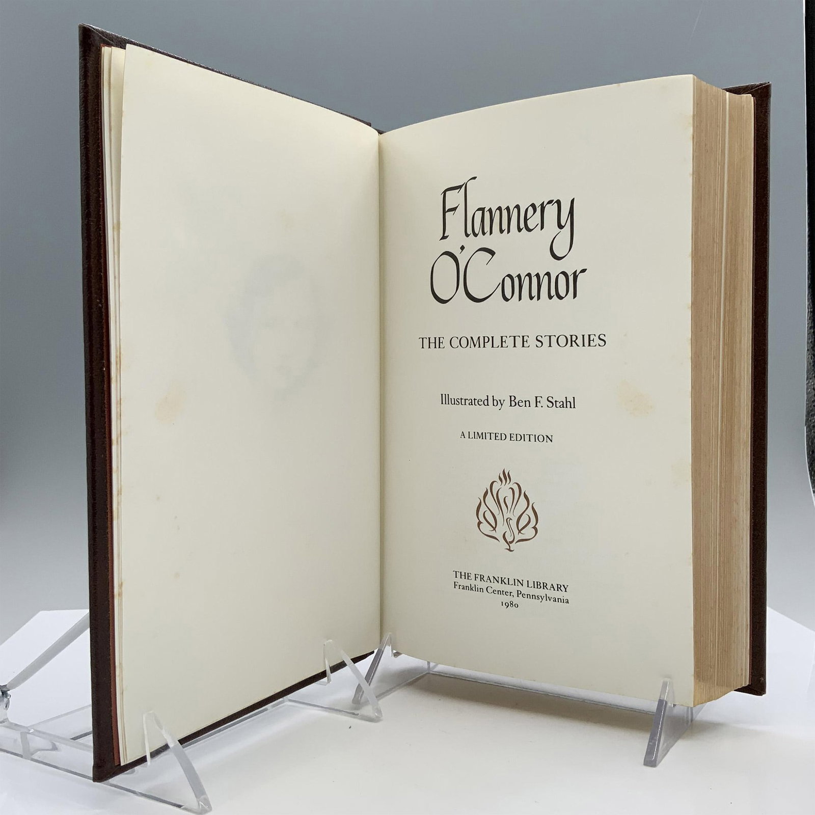The Complete Stories of Flannery O'Connor, The Franklin Library: Pennsylvania: Franklin Center, 1980. Hardcover book brown bound with gilded motif on the cover. Flannery O'Connor (1925-1964) was an American writer known for her Southern Gothic style. The Complete S