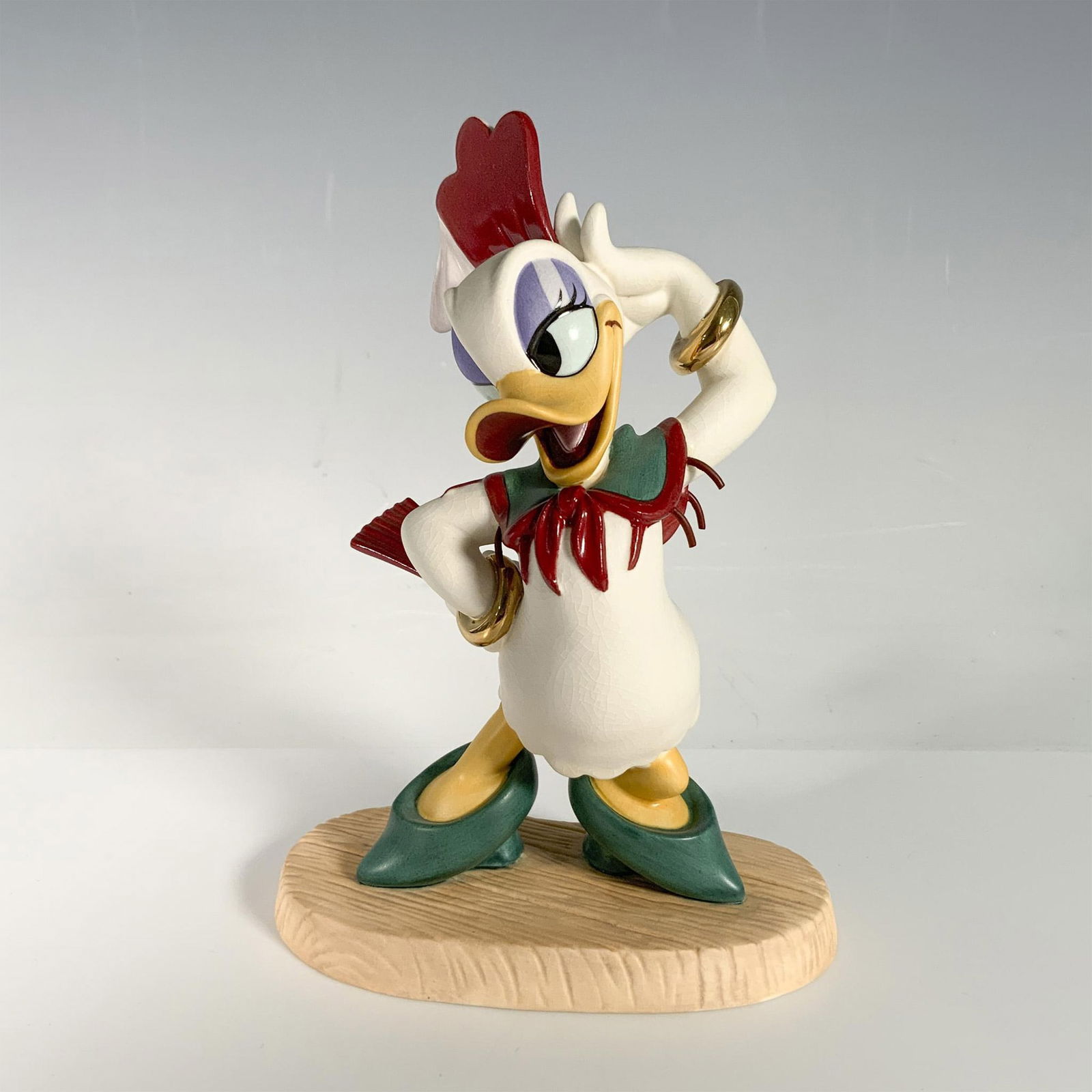 Walt Disney Classics Figurine, Daisy's Debut: This porcelain figurine features Daisy Duck as Donna Duck from the movie, Don Donald. WDCC and Gold Circle Dealer backstamps. Certificate of Authenticity included. This item has its original box measu