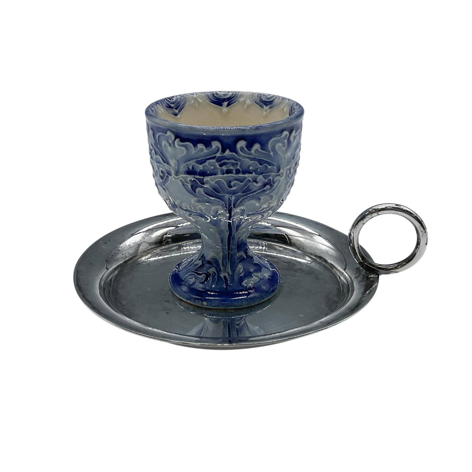 James Macintyre Florian Ware Egg Cup with Silver Plated Tray: A small blue English pottery egg cup in the Art Nouveau Poppy pattern designed by William Moorcroft. The cup incudes a Mappin & Webb silver plated tray with handle. The egg cup is initialed by William