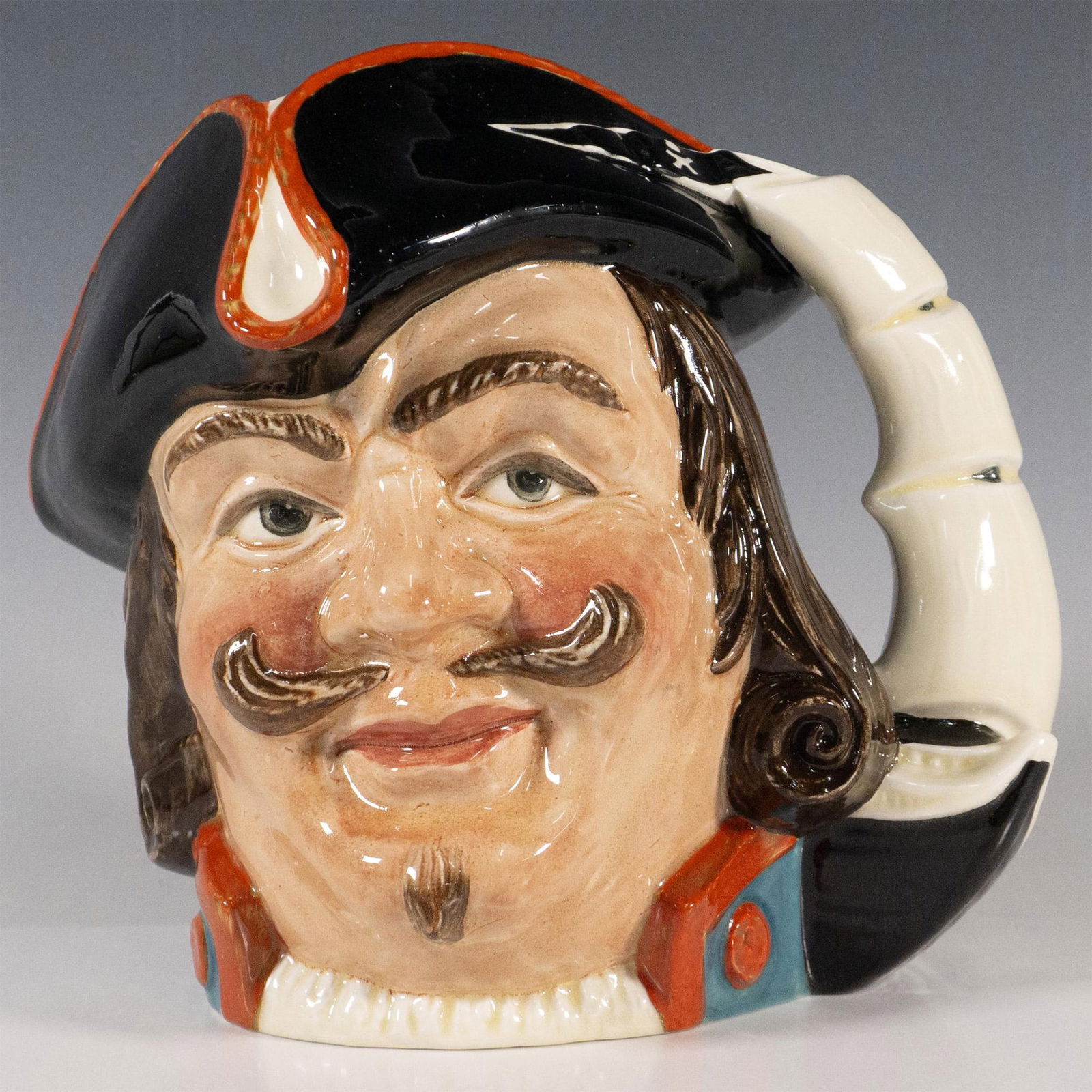 Capt Morgan (Colorway) - Large - Royal Doulton Character Jug: Capt Henry Morgan, D6467; figural jug blue coat with red accents with a black and red tricorn hat. A black ship with white sails as the handle. Royal Doulton backstamp. Artist: Garry Sharpe Issued: c.