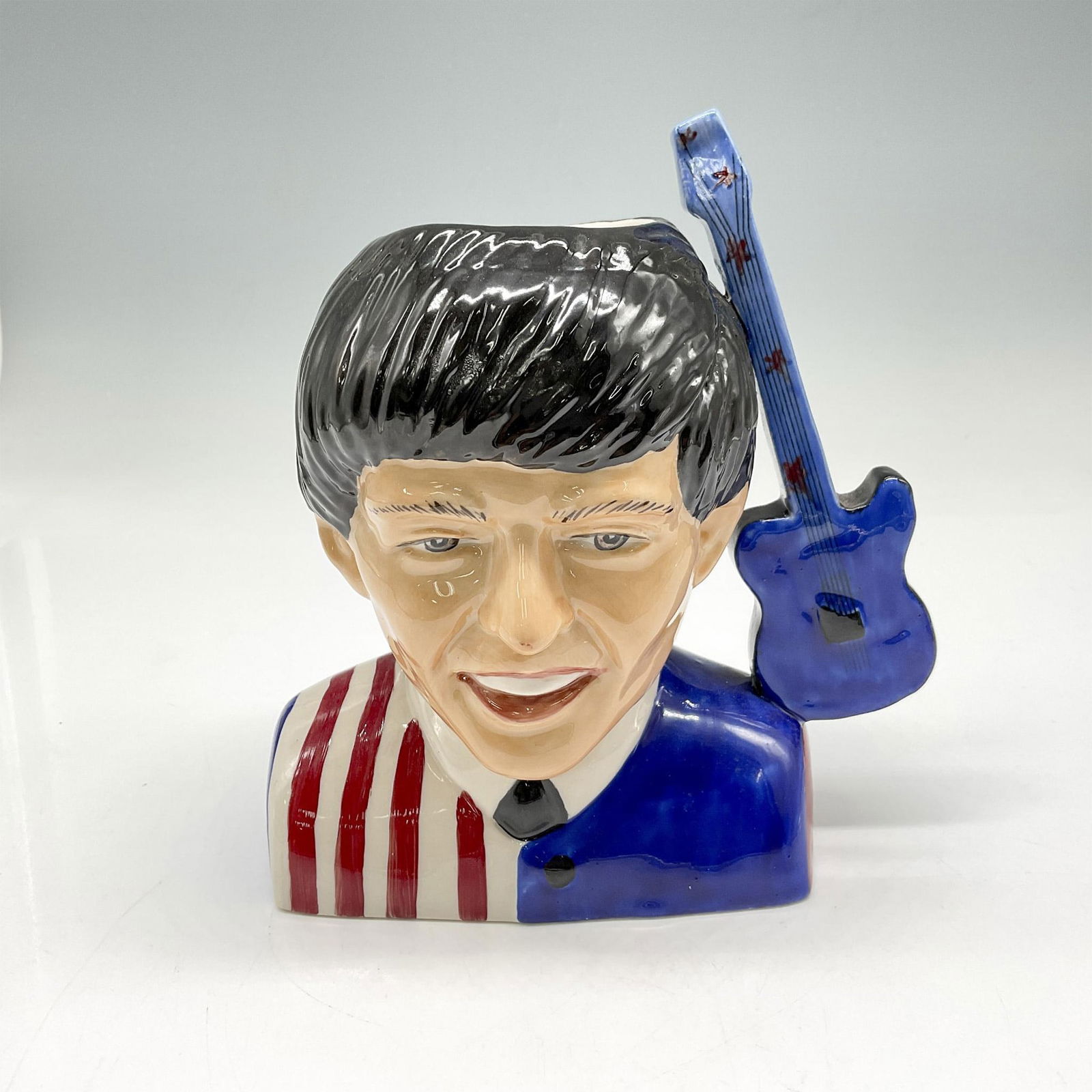 Kevin Francis Rare Artists Original Proof Beatles Character Jug, George Harrison: Glossy figure in striped red and white shirt with blue accent and blue designed guitar as handle. Kevin Francis and Margaret Jackson on base. Artist: Margaret Jackson Issued: 20th century Dimensions: