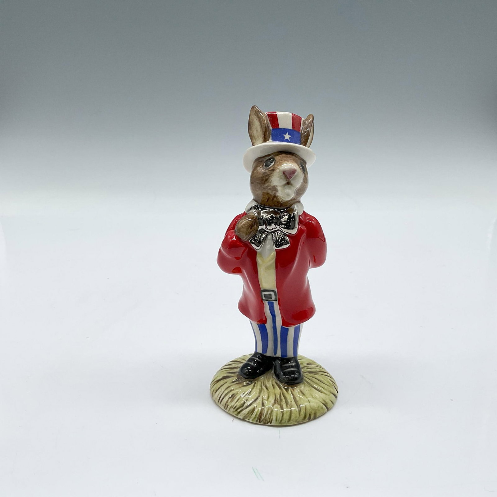 Uncle Sam DB175 - Royal Doulton Bunnykins: Special edition to commemorate the 10th Anniversary of the New England Chapter. Glossy porcelain figure is modeled in red, white and blue patriotic clothes with a platinum bowtie. Royal Doulton Bunnyk