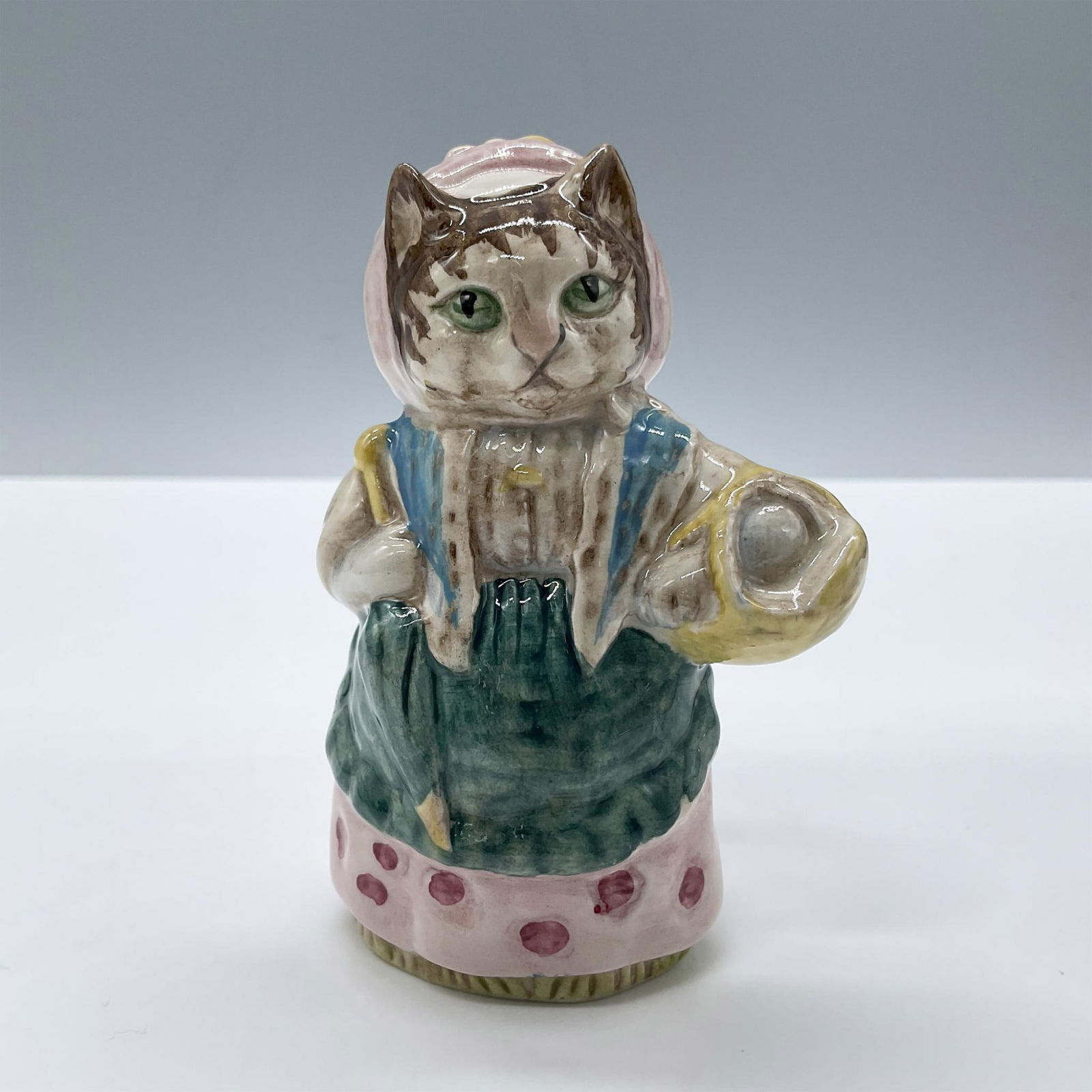 Beswick Beatrix Potter Figurine, Cousin Ribby: Glossy porcelain. Modeled in a pink dress, blue shawl and teal apron. Beswick Beatrix Potter backstamp. Issued: c. 1970 Dimensions: 2.25''L x 2.5''W x 3.5''H Manufacturer: Beswick Country of Origin: E