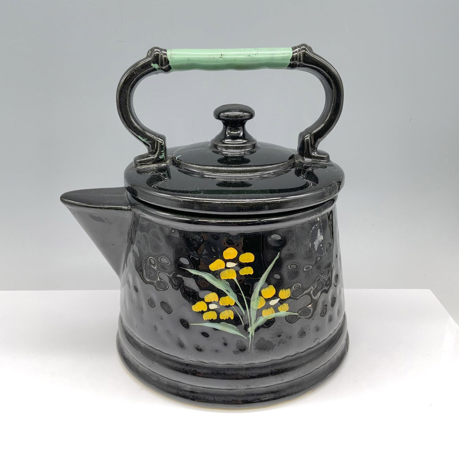 Mccoy USA Collectable Pottery, Black Teapot Cookie Jar: Gorgeous black colored and hand painted container used to store cookies that is themed as a vintage tea kettle. McCoy backstamp. Issued: 20th century Dimensions: 9.25"L x 7.75"W x 9"H Manufacturer: Mc