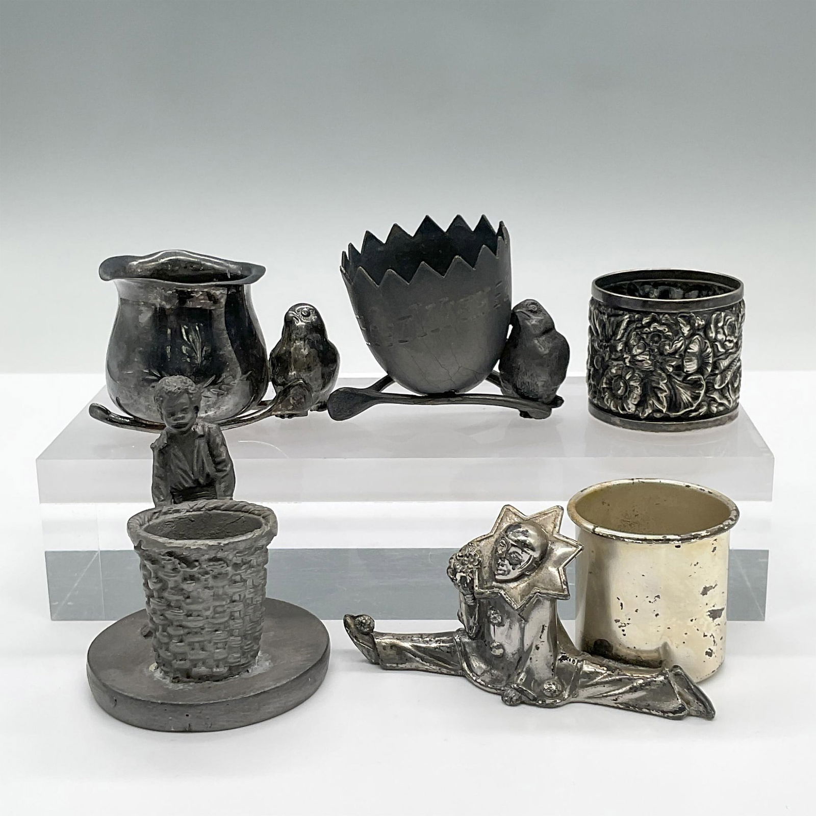 5pc Metal Toothpick Holders: This charming variety of metal toothpick holders features a pierrot in a split, two birds, a floral design and a boy with a basket. Largest measures 4"L x 2.25"W x 2"H. Issued: 20th century Dimensions