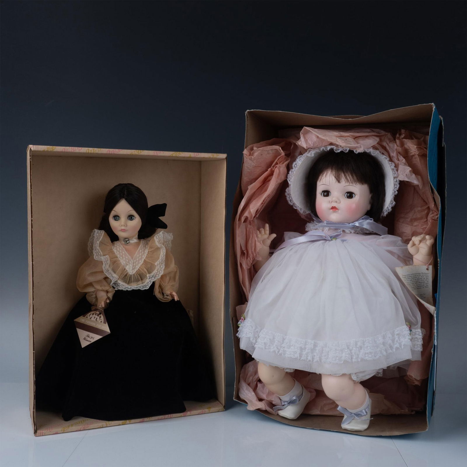 2pc Vintage Madame Alexander and Effanbee Dolls: Features a darling Madame Alexander Mommys Pet Doll and an Effanbee The Passing Parade Doll. This item has its original box. Boxes measure 11.75"L x 5.5"W x 17"H and 13"L x 6"W x 19"H. Dolls measures