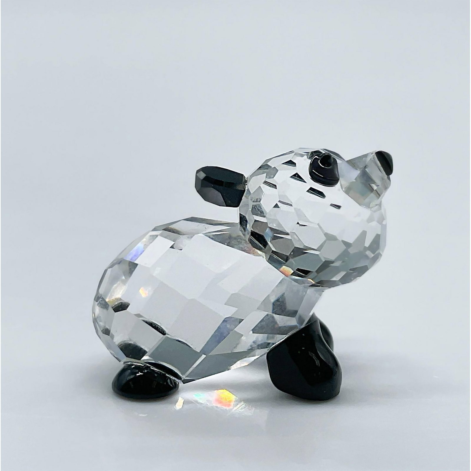 Swarovski Crystal Figurine, Panda Baby: This adorable little crystal panda features black paws, ears, eyes and nose. This item has its original box measuring 3.25"L x 3.25"W x 2.5"H. Certificate of Authenticity included. Swarovski acid mark
