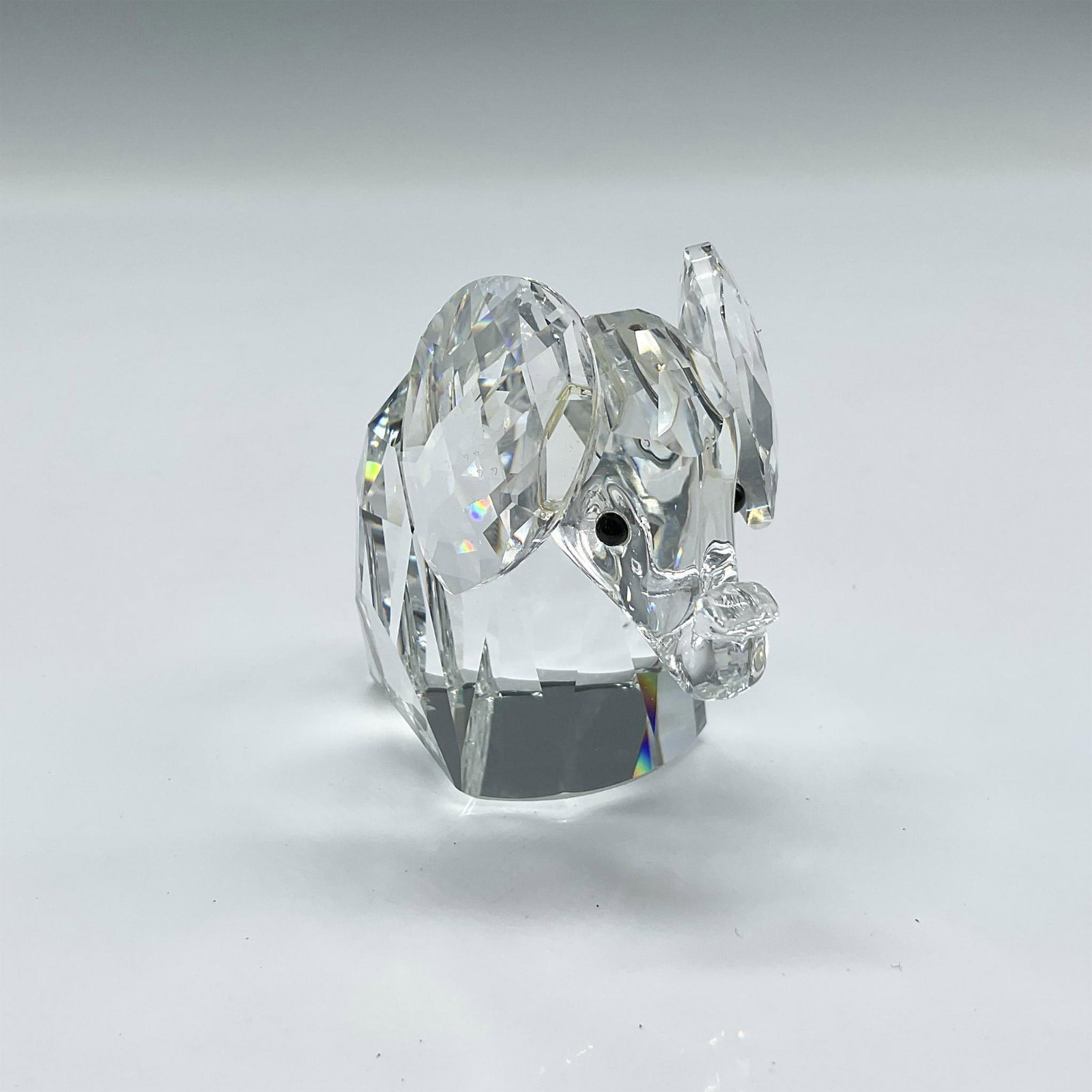 Swarovski Silver Crystal Figurine, Lg Elephant w/Metal Tail: Part of the African Wildlife collection this faceted crystal figure has black crystal eyes and a floppy metal tail. Swarovski backstamp. 010015. This item has its original box 4"H x 5" dia. Artist: Ma